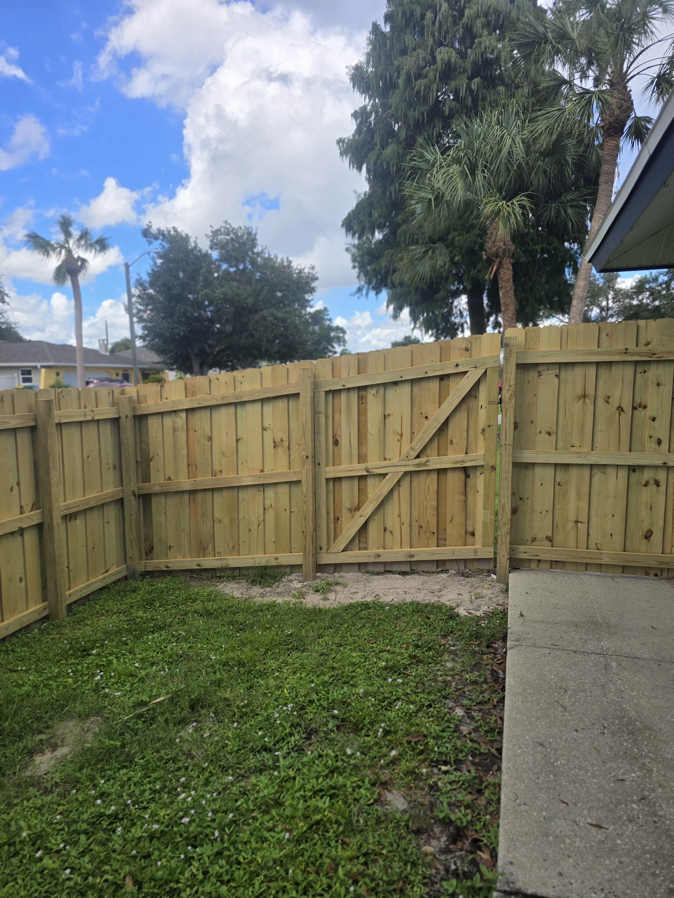 Wood Privacy Fence Installation with Double Gate in Port Charlotte by True Fence LLC