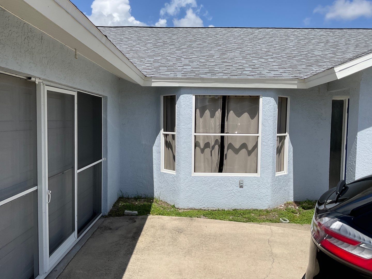 New White Seamless Gutters with Downspouts and Splash Guards in Cape Coral FL by Gutter Professors
