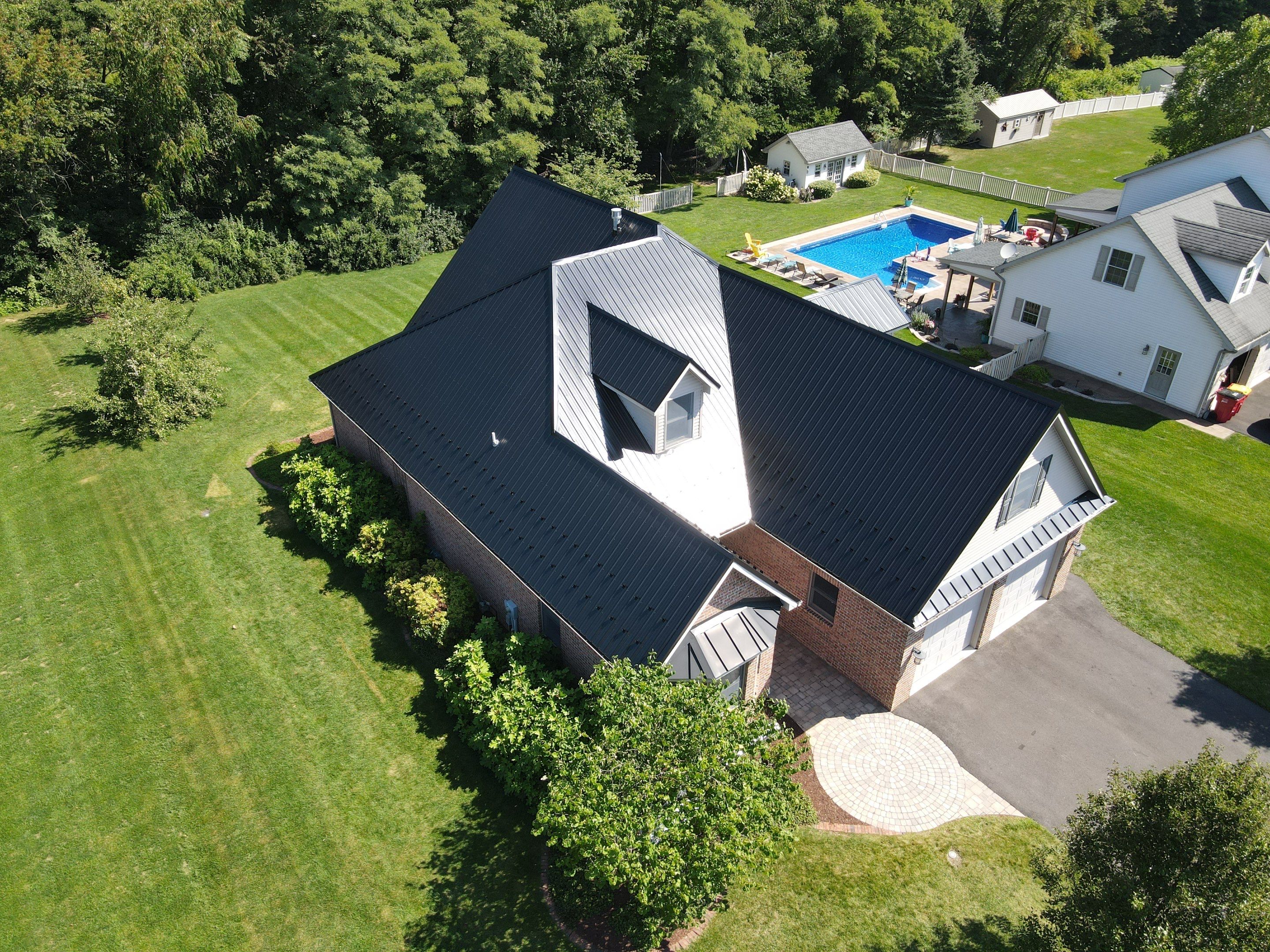 Standing seam / Azm panel in black  by Teflon Roofing