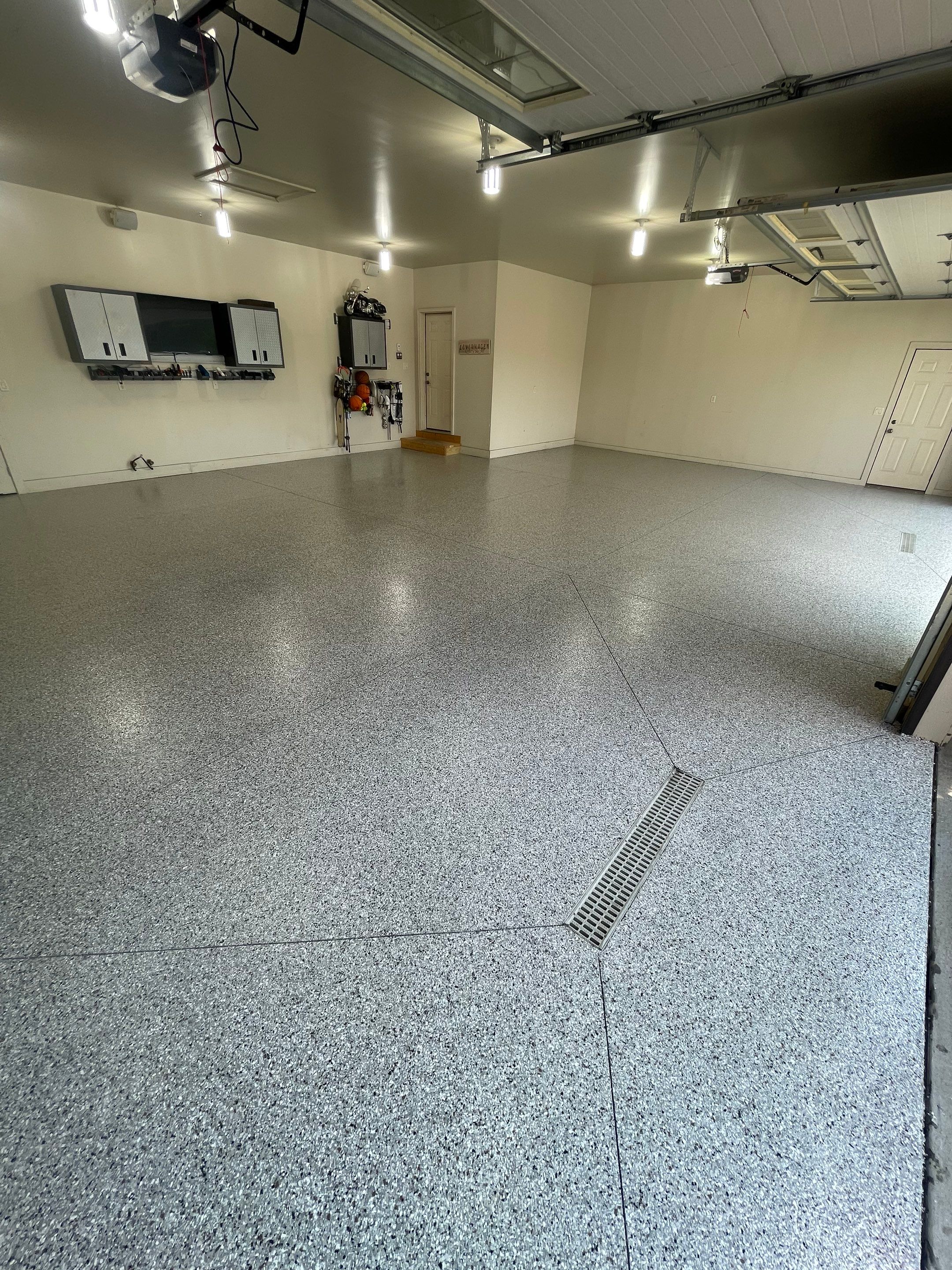 Coyote Flake Garage Floor Coating in Sioux Falls with Trench Drain by Select Painting, Coatings & Garage Cabinets