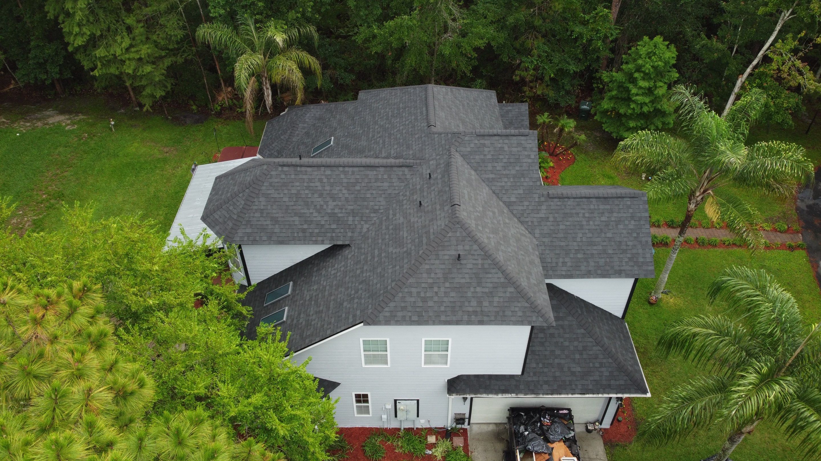 Complete Onyx Black Asphalt Shingle Roof Replacement and Skylight Installation in Jacksonville by Trinity Restoration and Roofing LLC