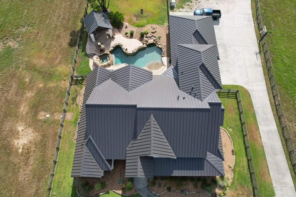 Residential Roofing Installation using Stamding Seam Metal by STX Roofing