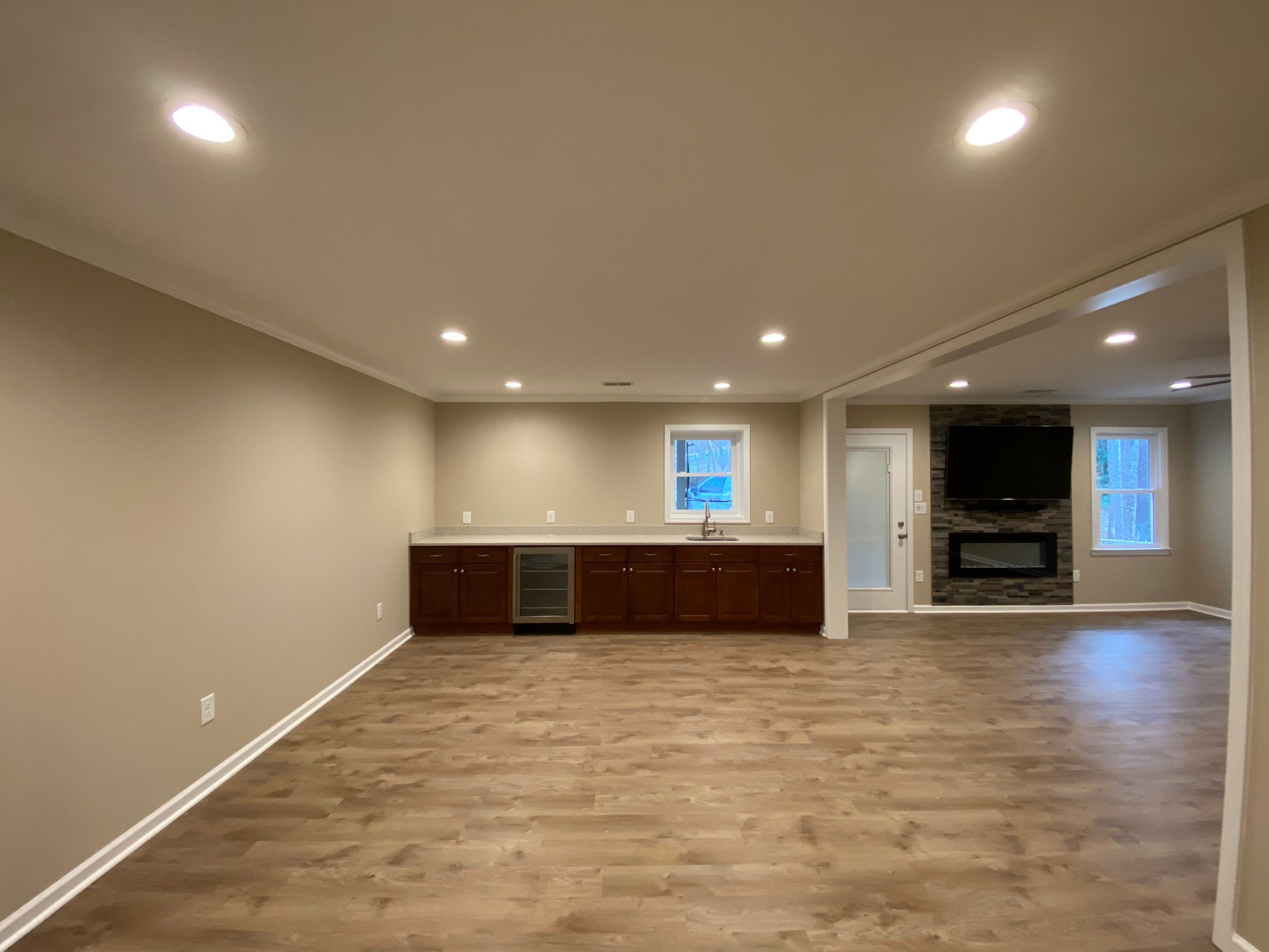 Acworth Basement Transformation With Wet Bar and Stone Fireplace by Swift Home Renovations