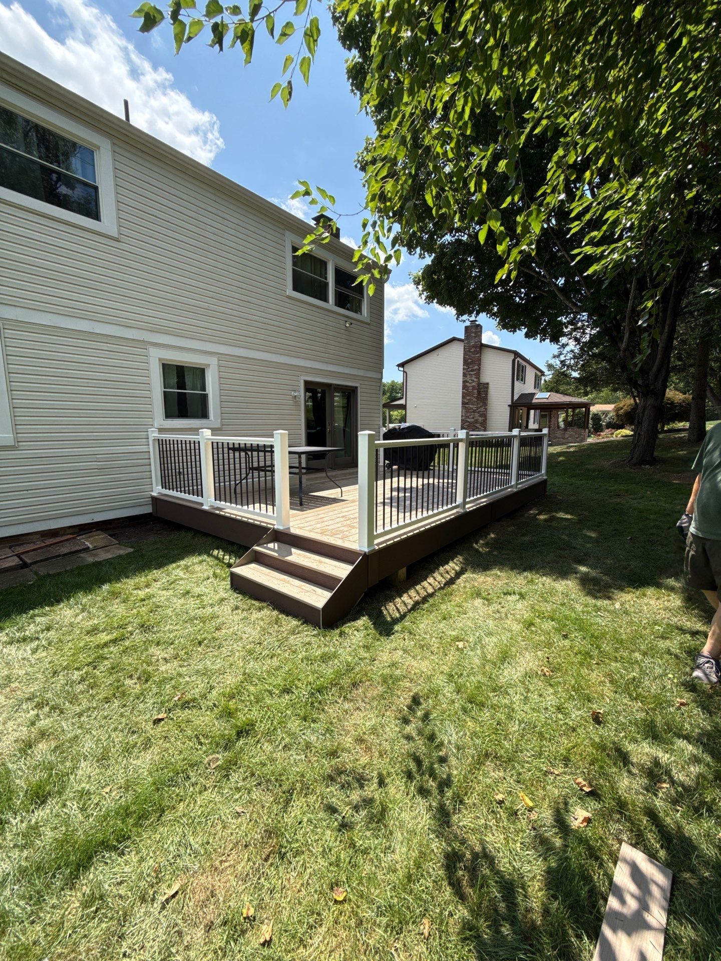 Bridgeville Composite Deck Build with White Railings and Versalok Retaining Wall by Cousins Roofing Siding & Decks