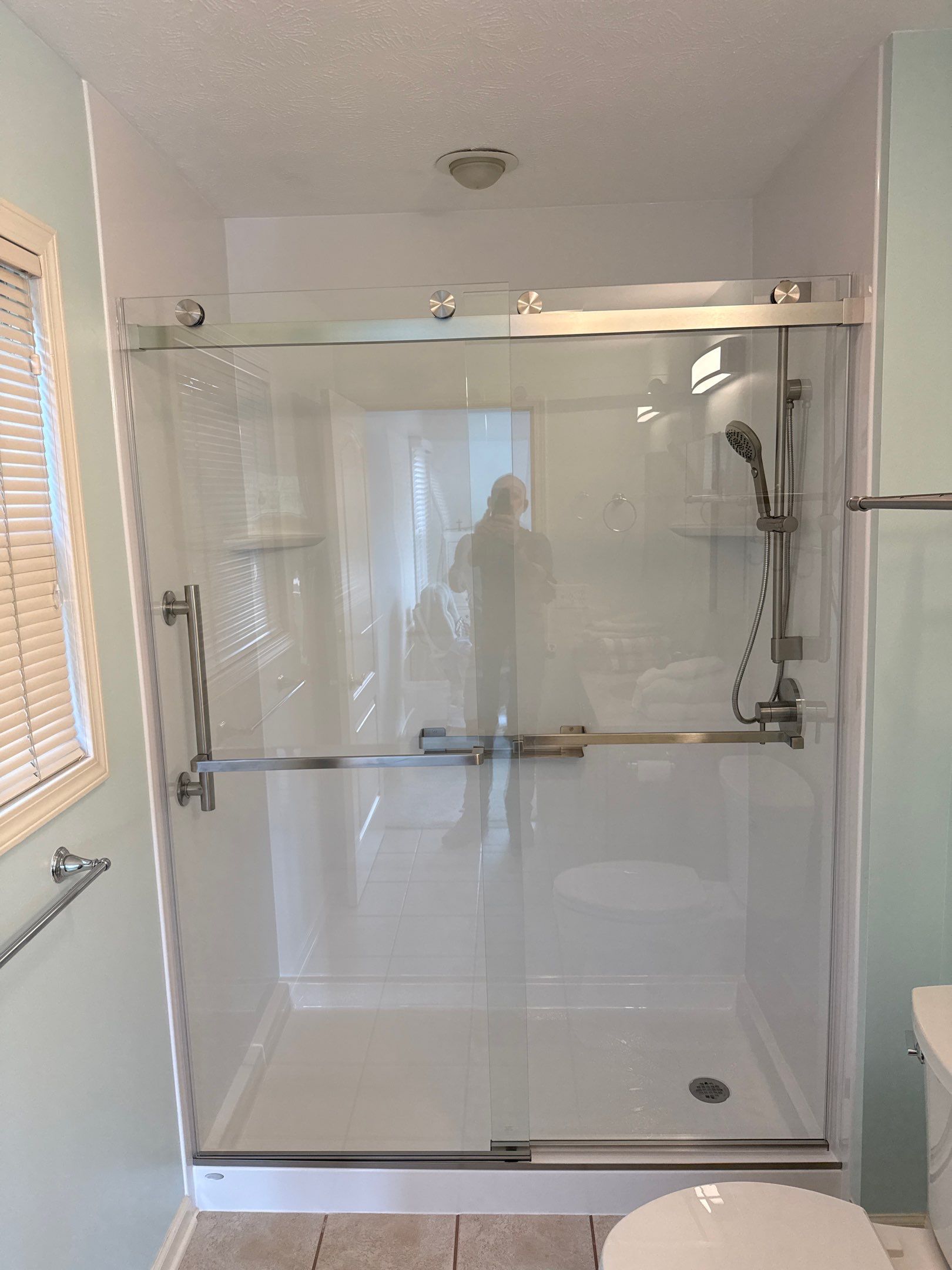 Sliding Glass Shower Door and Bathtub Surround Installation in Manistee by Rainbow Seamless Systems