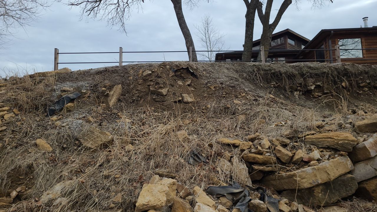 Supporting back of home with backfill at edge of steep creek by LAND ESCAPES LLC
