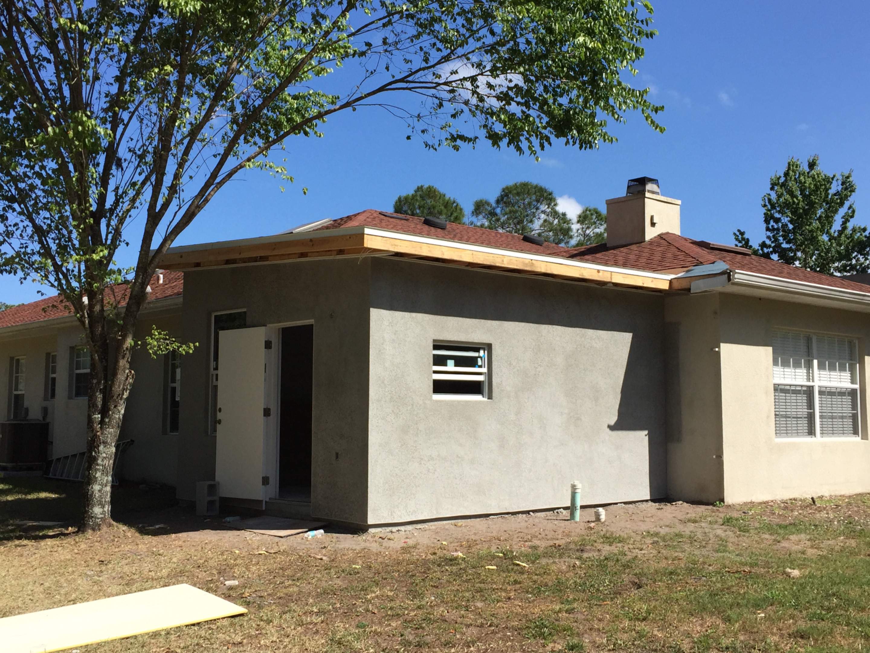 Residential Bedroom Addition with Concrete Slab and Stucco in Palm Bay by Florida Roofing and Renovations Inc.