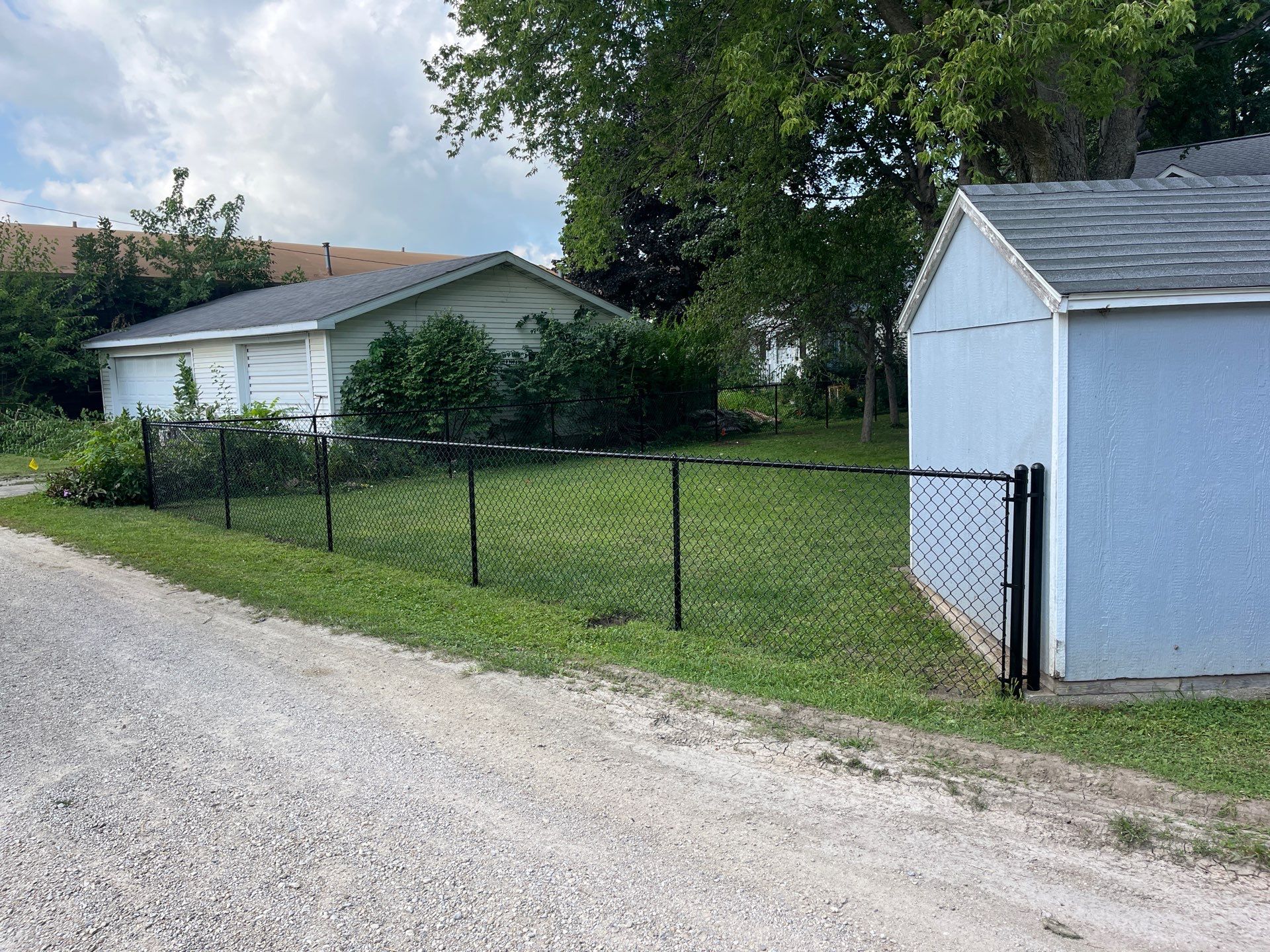 Black Chain Link Perimeter Fence and Gate Installation in Shell Rock by Perfect Picket Fence and Stain