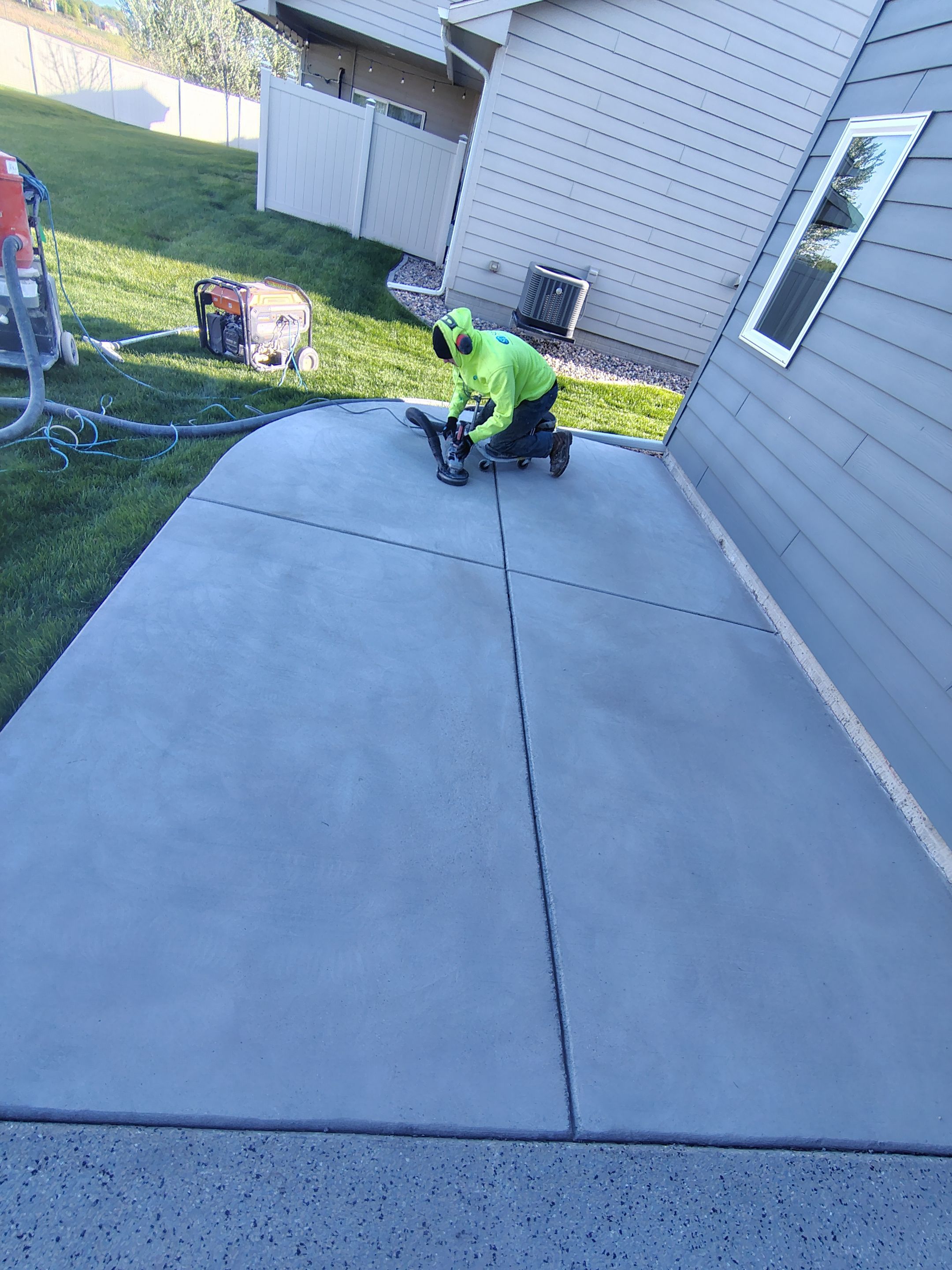 Speckled Concrete Patio Coating Installation in Sioux Falls by Select Painting, Coatings & Garage Cabinets