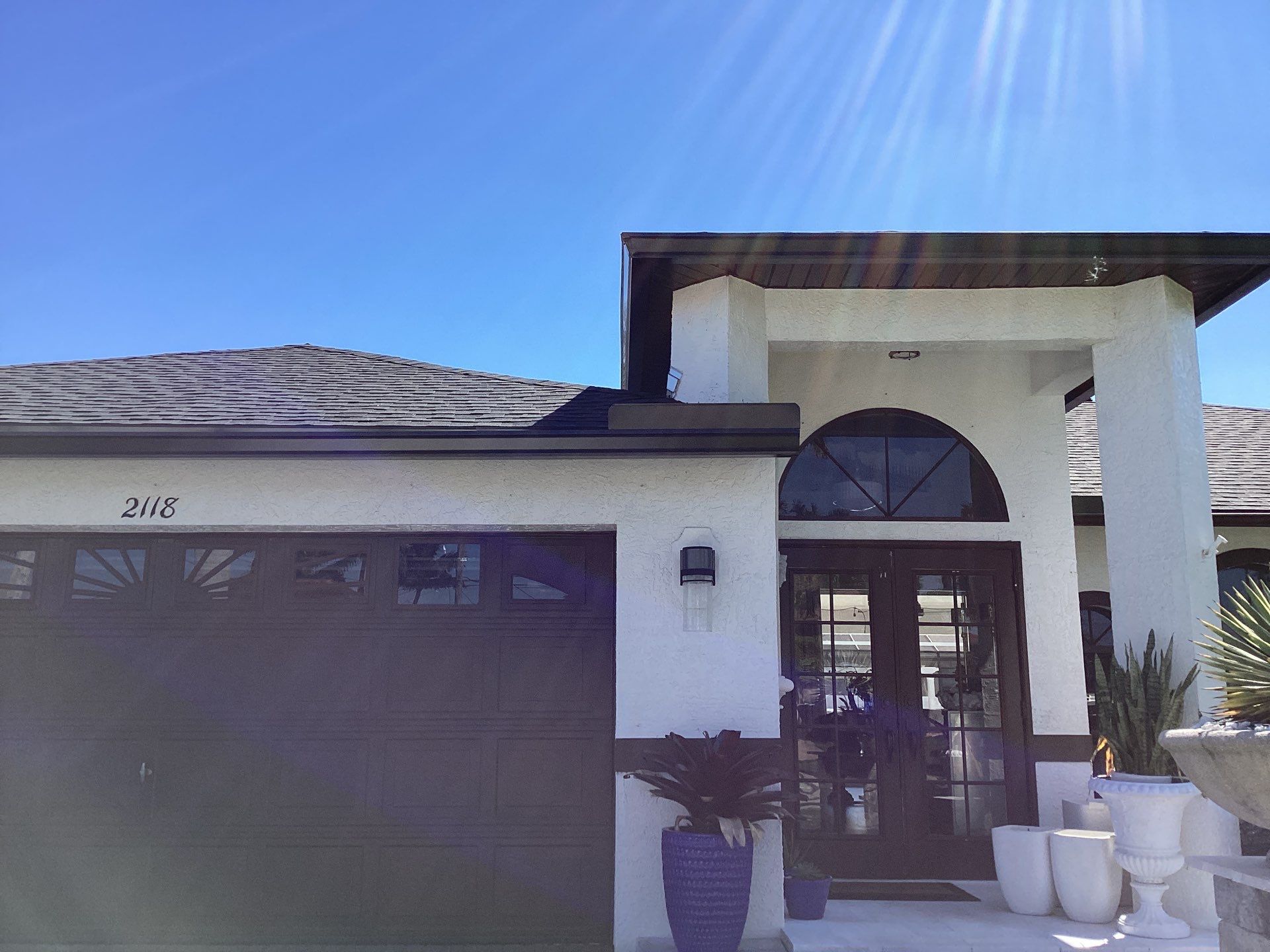 Brown Gutter + White and Brown Downspouts in Cape Coral FL by Gutter Professors