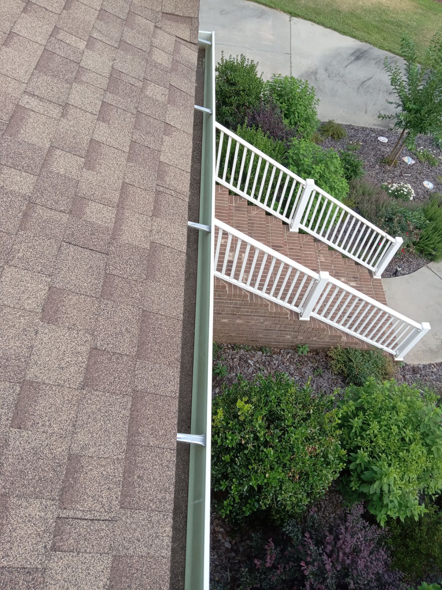 pressure washing roof shingles driveway sidewalk and fence removing dirt buildup and stains restoring appearance