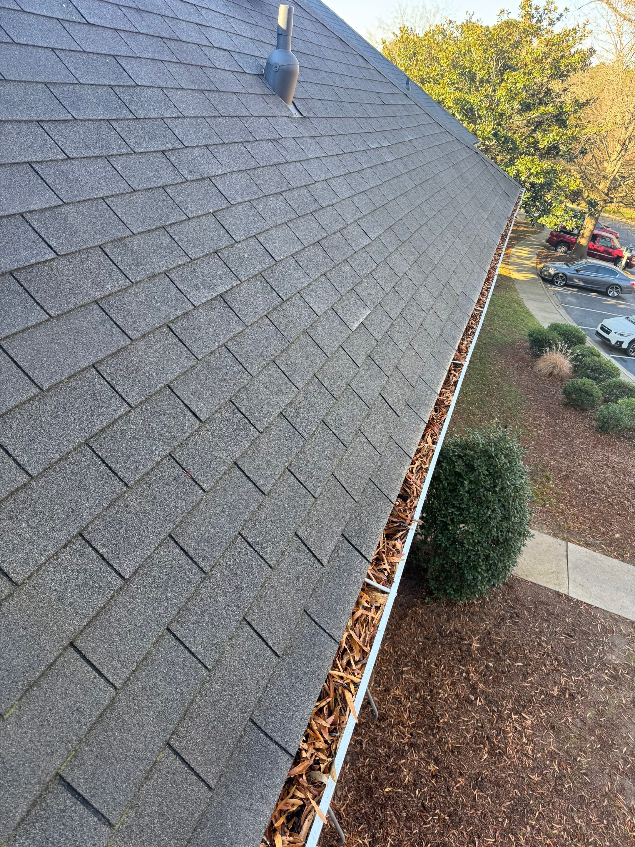 HOA gutter cleaning in Fuquay-Varina & Holly Springs, NC,before photo showing full gutters.