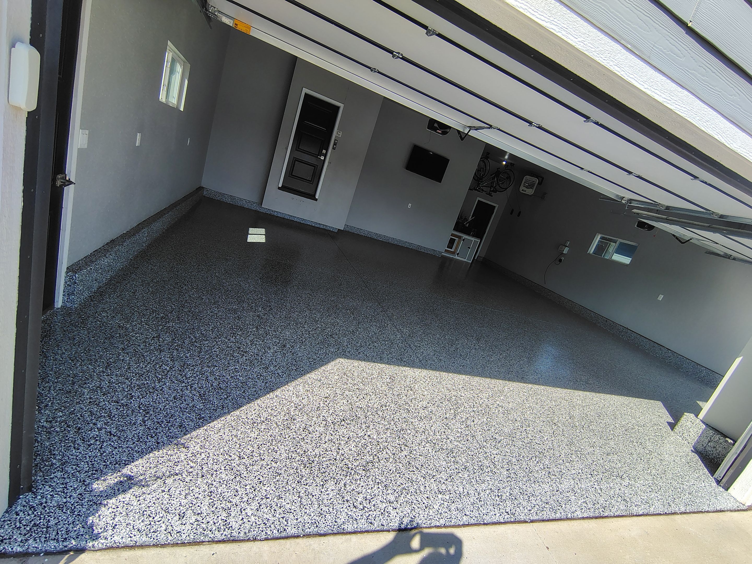 Custom Gray Flake Garage Floor Coating in Sioux Falls by Select Painting, Coatings & Garage Cabinets