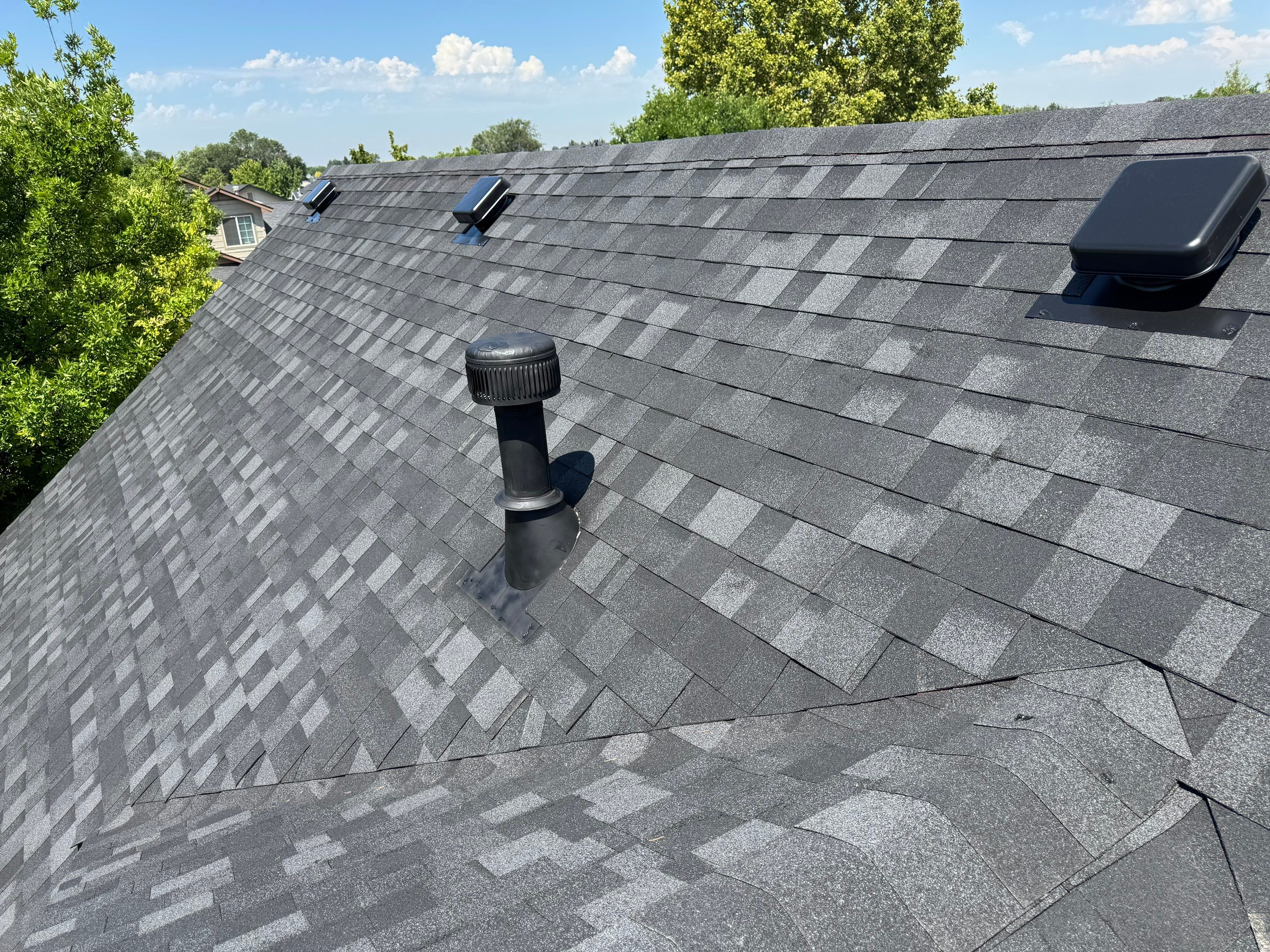 Residential Roof Replacement Featuring Charcoal Grey Architectural Shingles by Olive Roofing