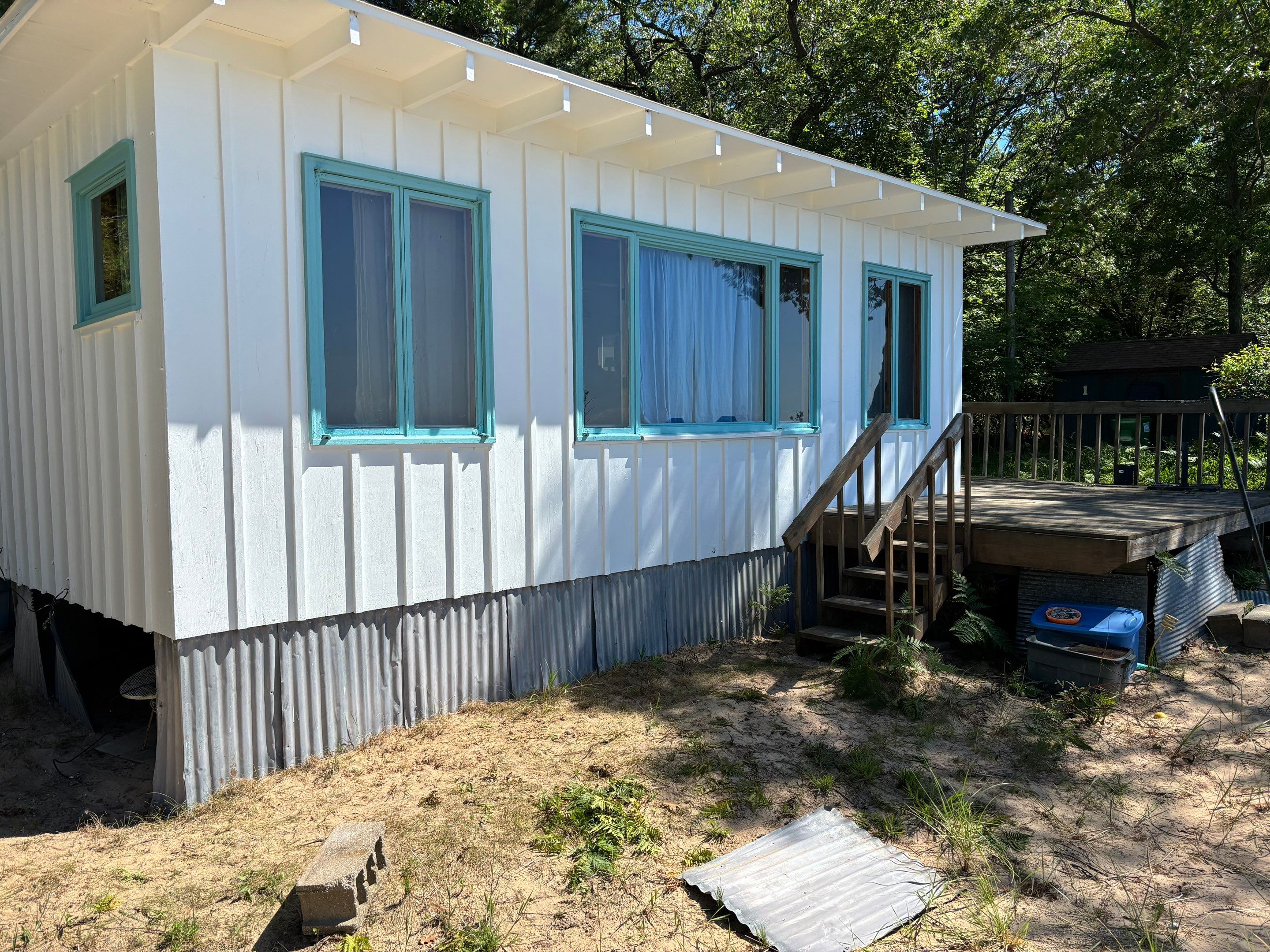 Lakeside Cottage Exterior Painting and Teal Trim Restoration in Mears by Gordon Painting