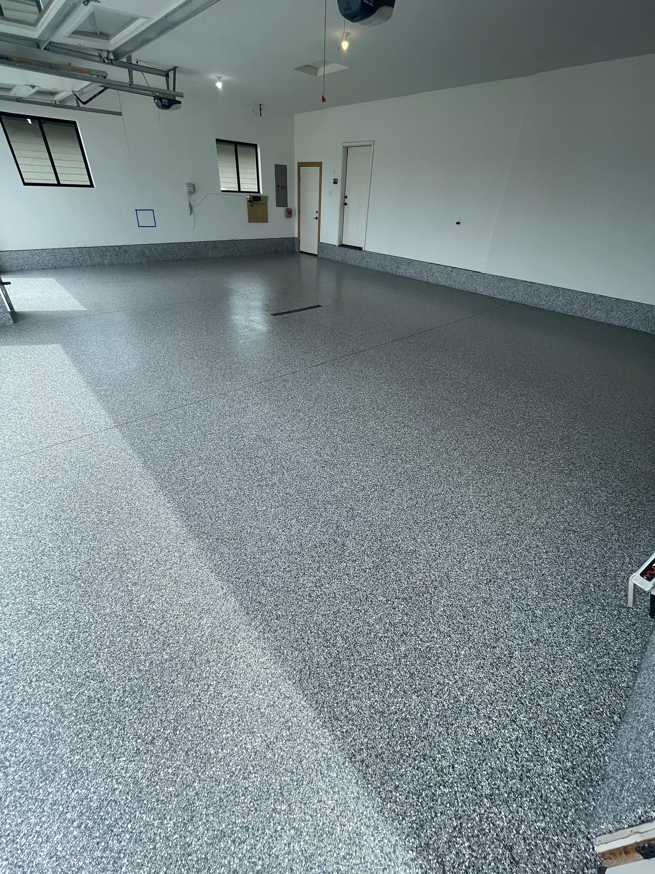 Full Garage Concrete Coating with Grey Speckled Epoxy in Brandon by Select Painting, Coatings & Garage Cabinets