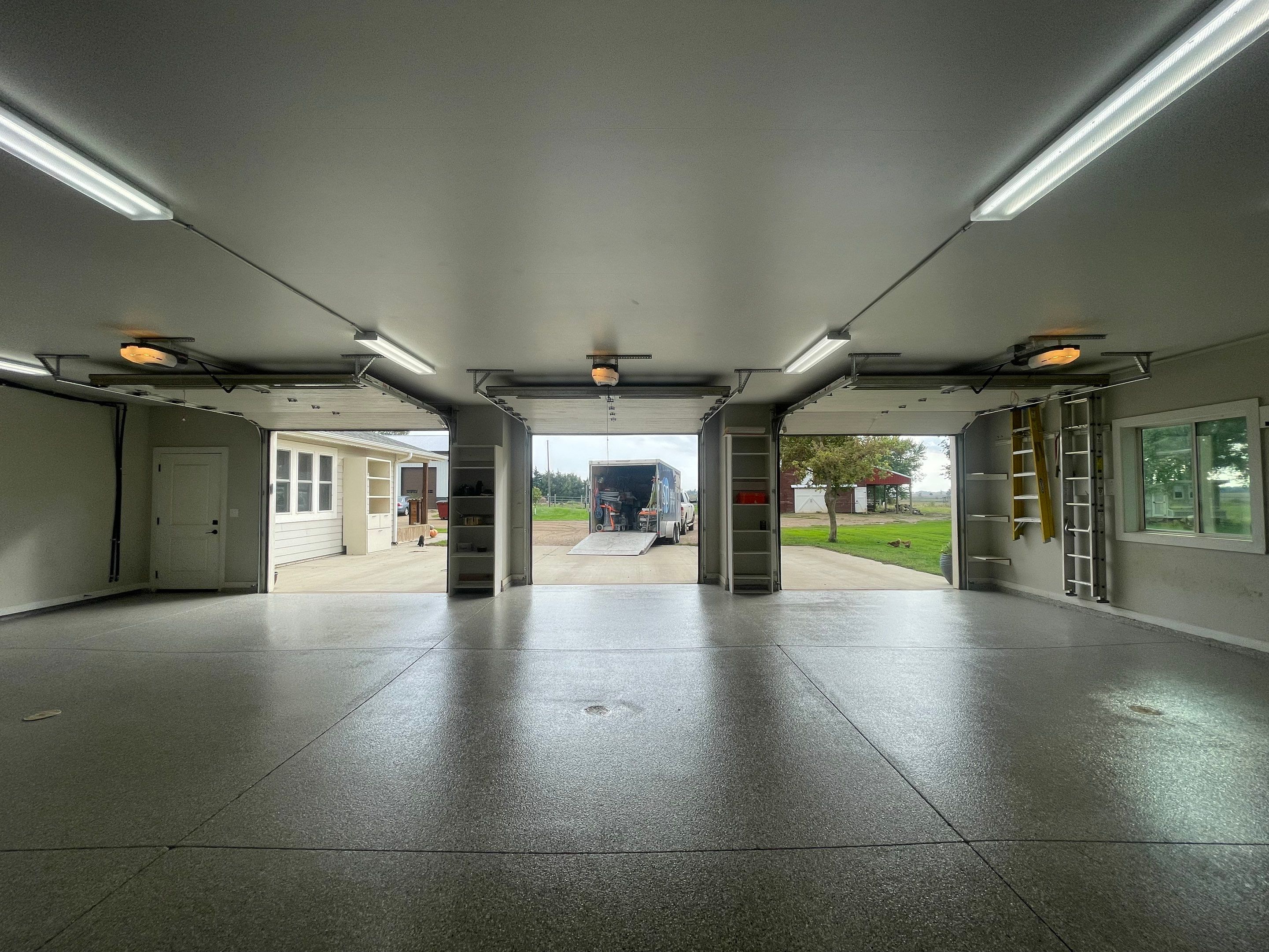 Grey Speckled Polyuera Garage Floor Coating for Hartford Three-Car Garage by Select Painting, Coatings & Garage Cabinets