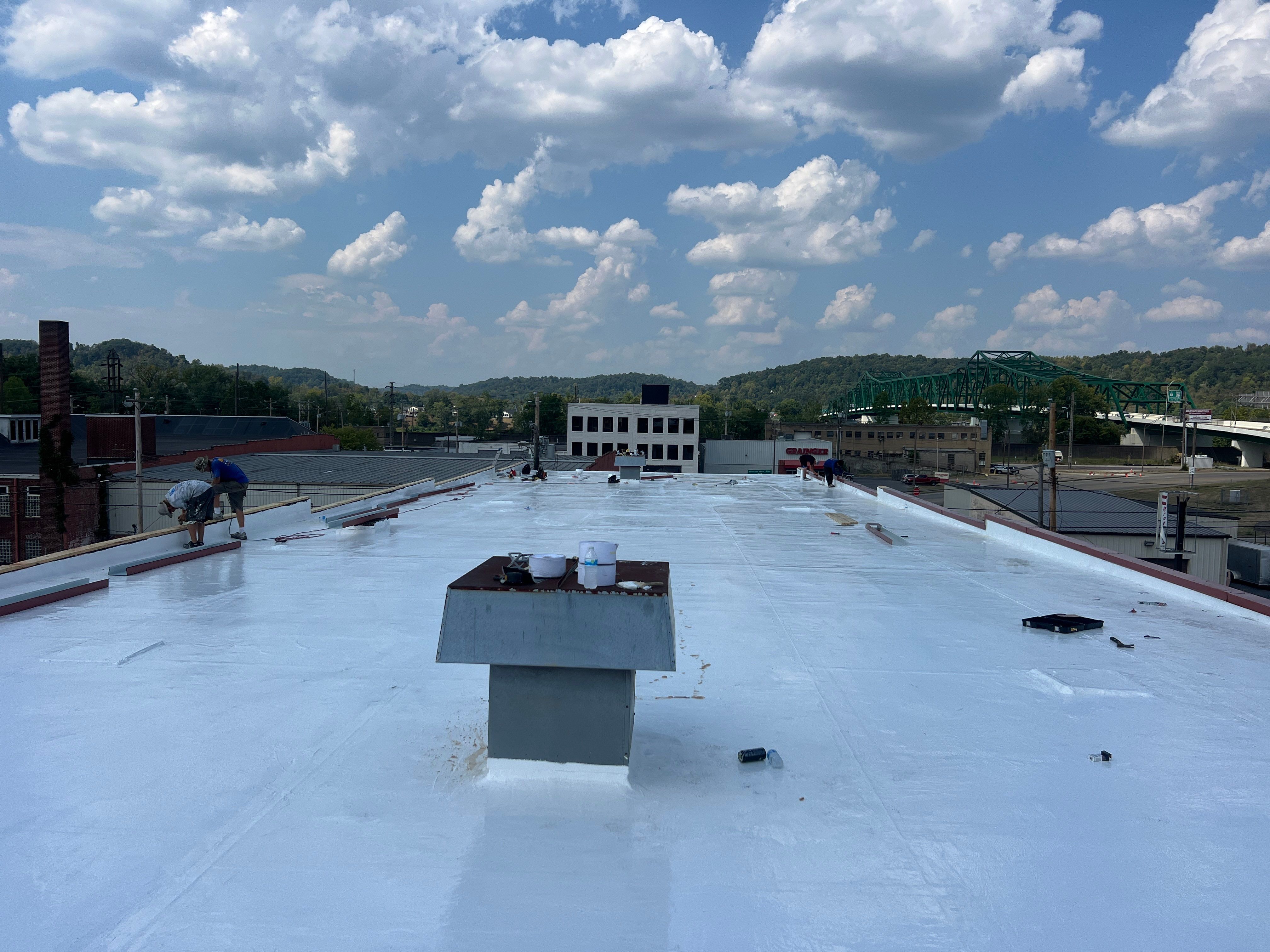 Commercial Roofing Installation using smartcoat Roof coating by Fahey Roofing + Contracting