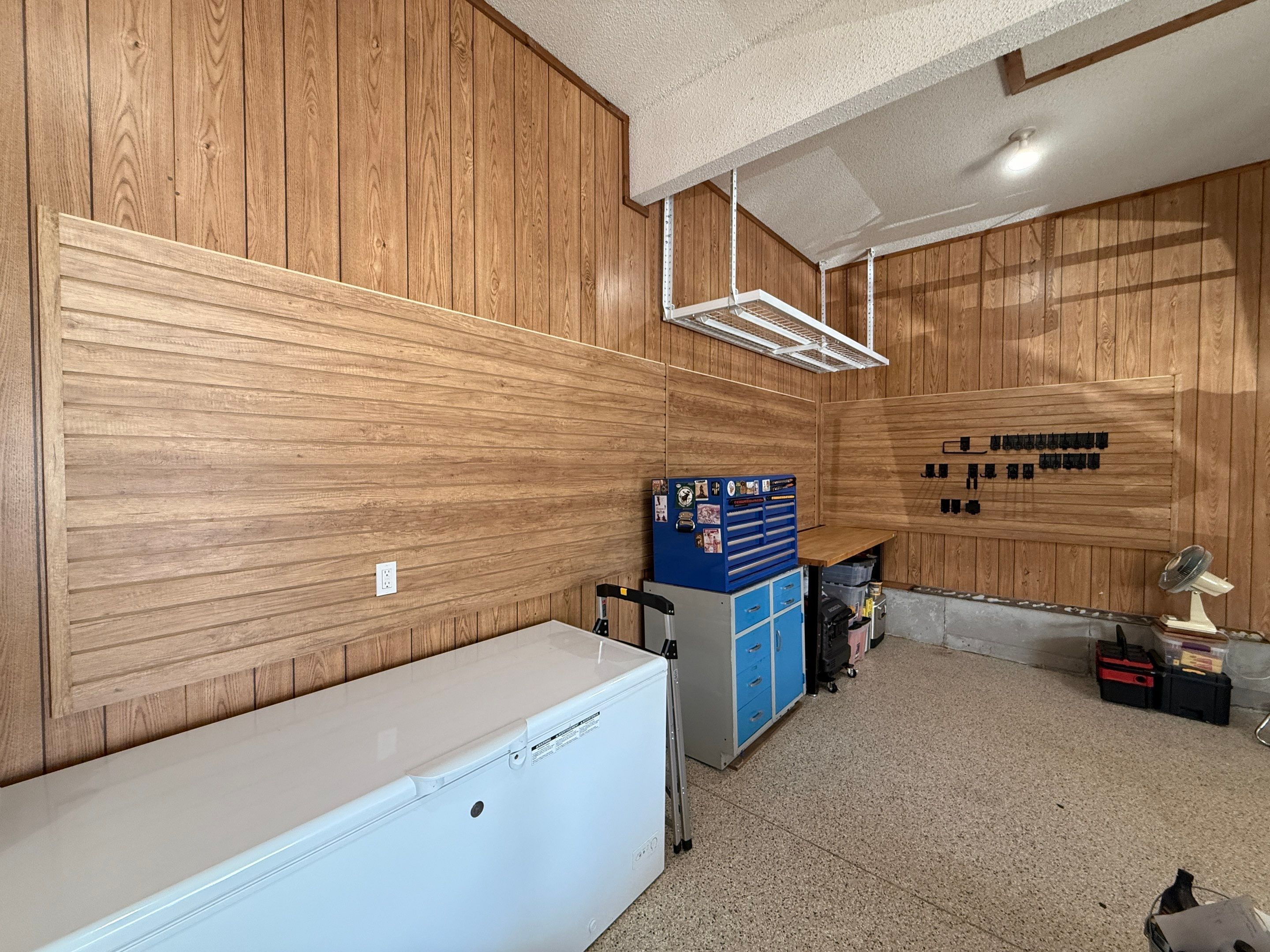 Garage Organization With Overhead Racks and Slatwall in Overland Park by Banner Garage