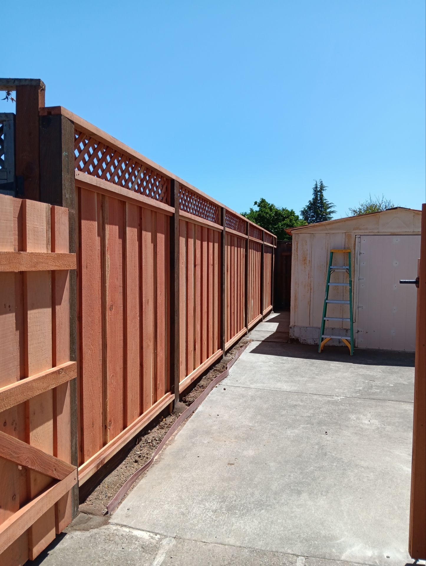 Board on Board with 1' Triple Lattice - 8' / 6' High by Fremont Fence Inc