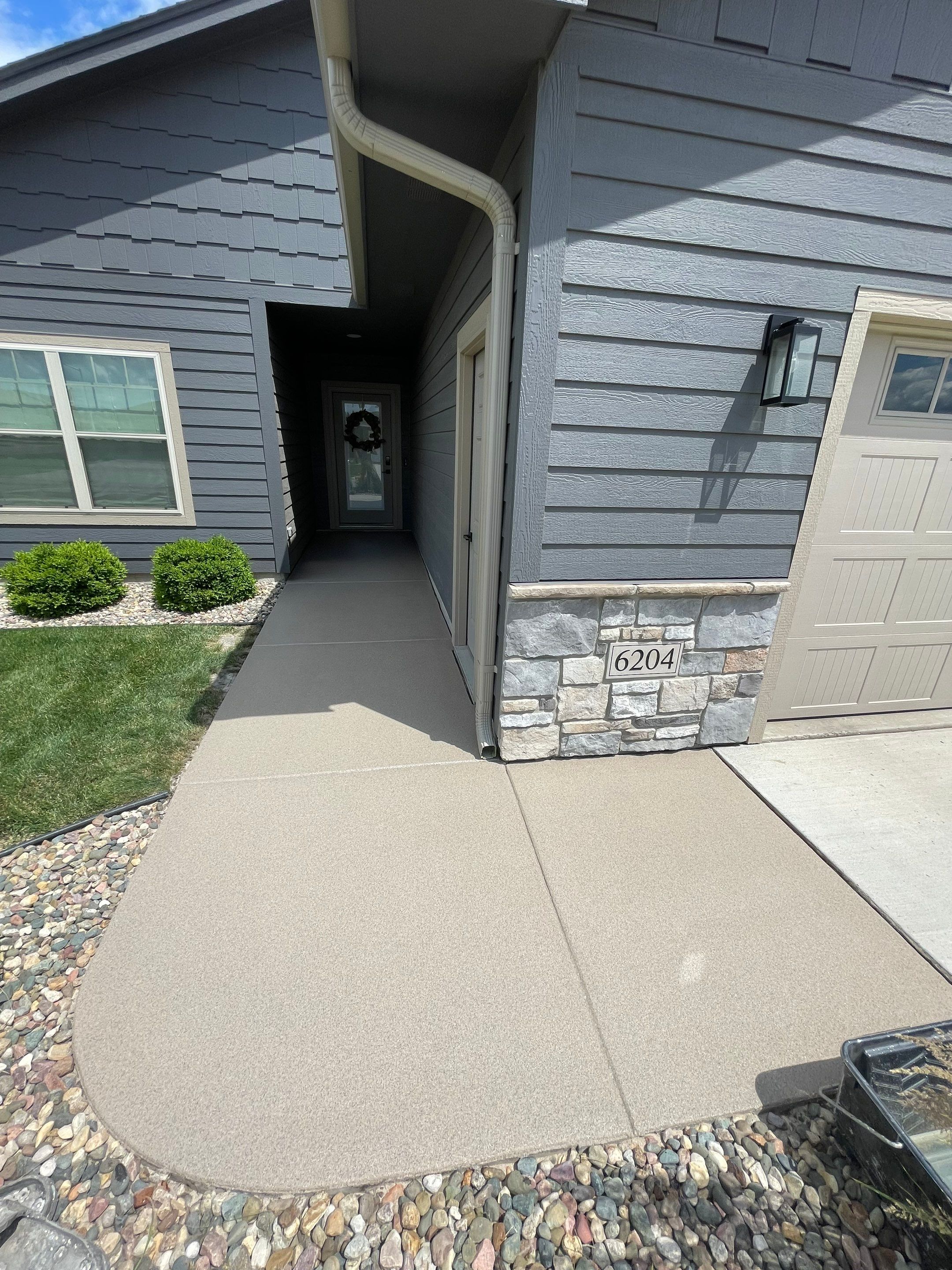 Textured Concrete Patio Coating and Custom Privacy Pergola in Sioux Falls by Select Painting, Coatings & Garage Cabinets
