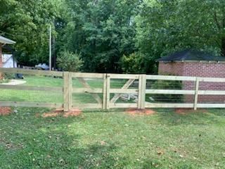 Fence Installation of 3 Rail Ranch with Wire Backing by Titans of Timber Fence & Stain