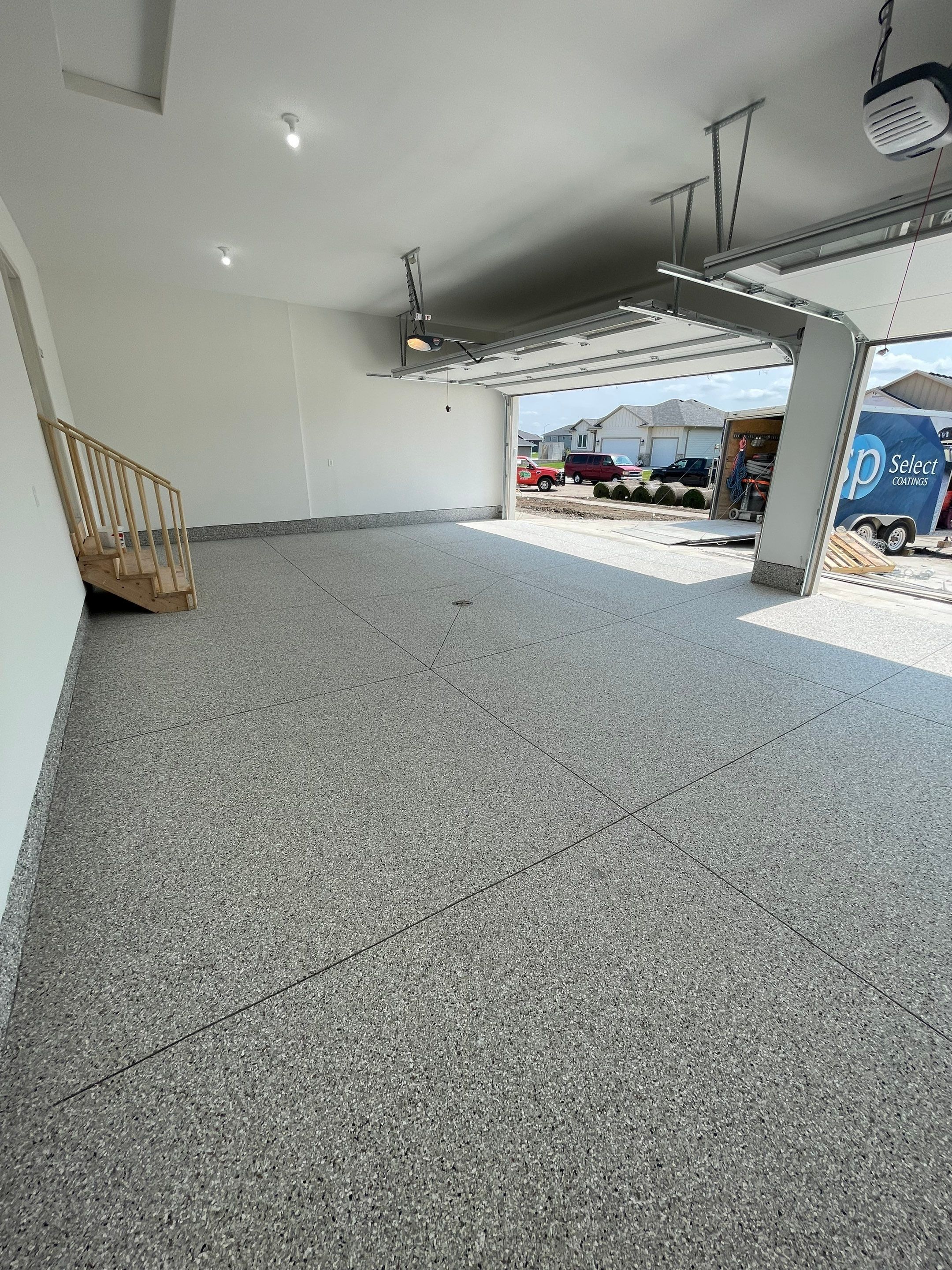 Grey Speckled Garage Floor Coating in Sioux Falls by Select Painting, Coatings & Garage Cabinets
