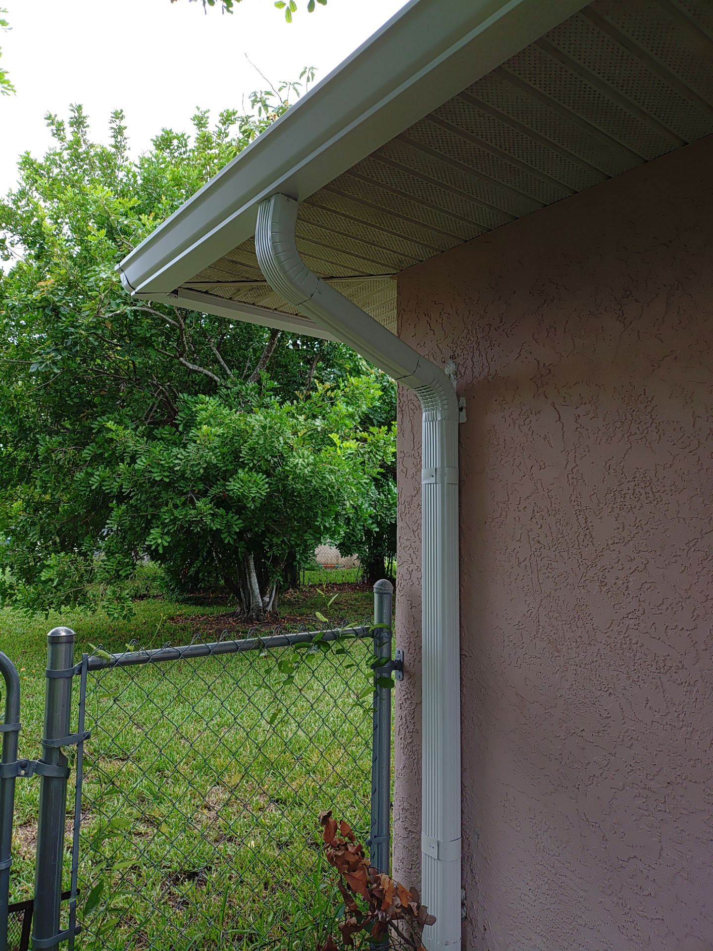Replace gutter using White Down Spouts in Cape Coral FL by Gutter Professors