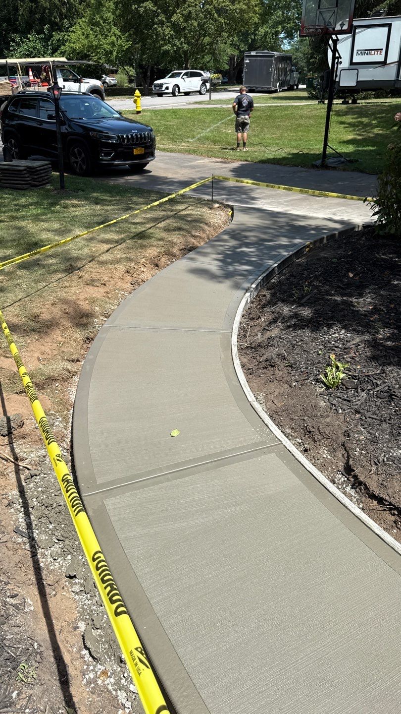 Broom finished concrete patio and sidewalk  by NG Masonry & Construction LLC