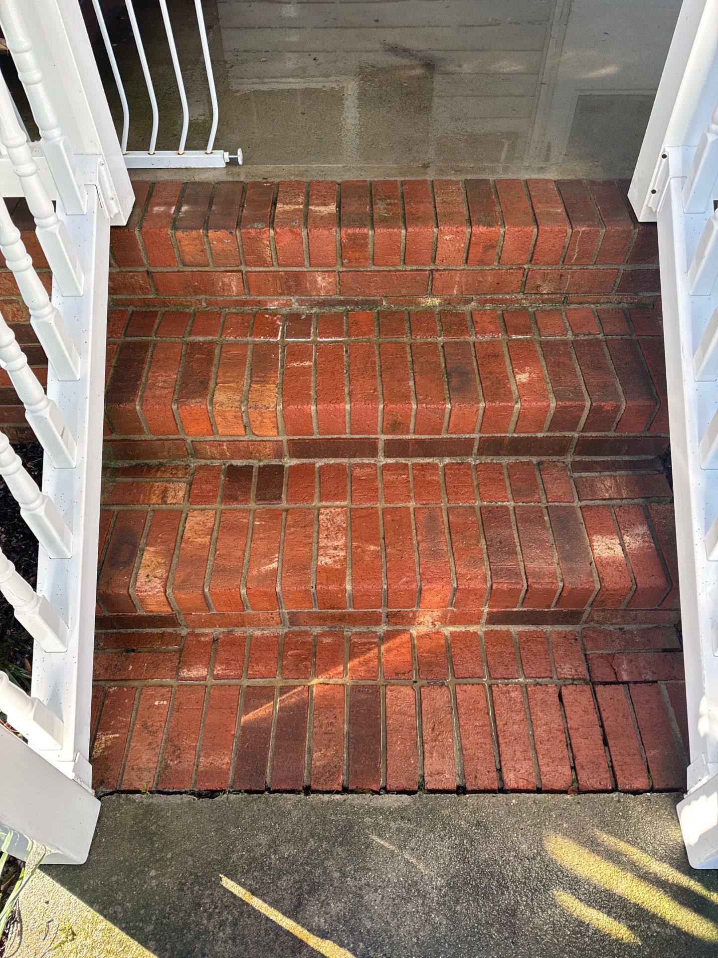 the image shows brick steps being cleaned with pressure washing to remove dirt and stains for a revitalized appearance