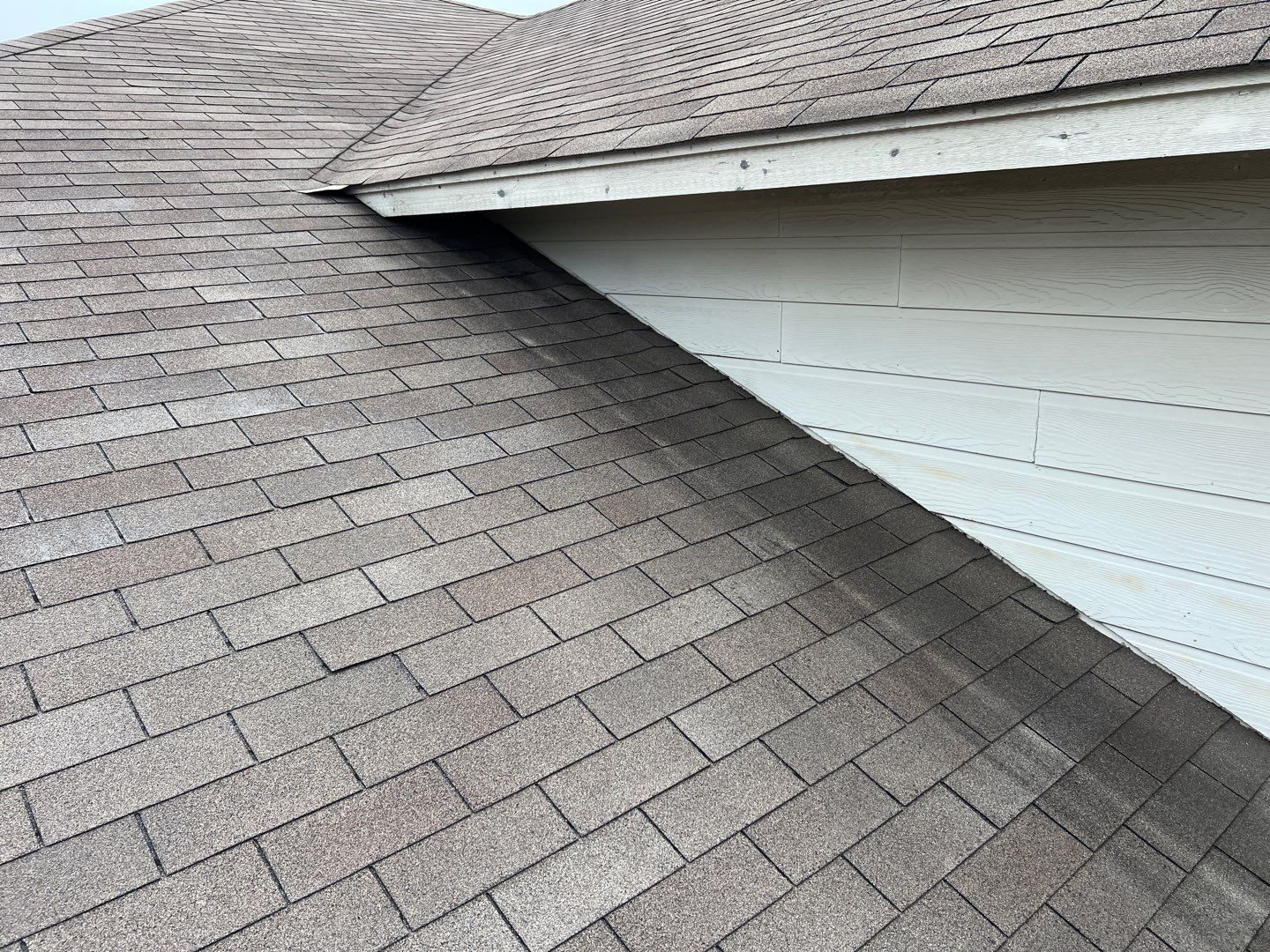 Wind damaged roof replacement by Oakwood Roofing and Construction, LLC