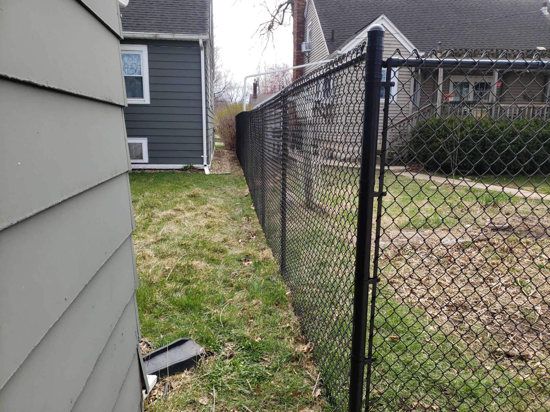 Black Vinyl Coated Chain Link Fence Installation in Waterloo by Perfect Picket Fence and Stain