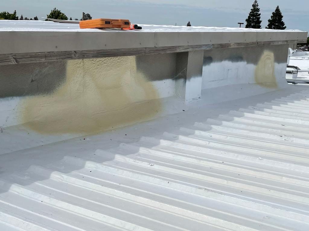 Metal roof restoration on commercial roof using Conklin Benchmark/ PUMA XL acrylic coatings over metal and foam by Straight Edge Roofing Inc