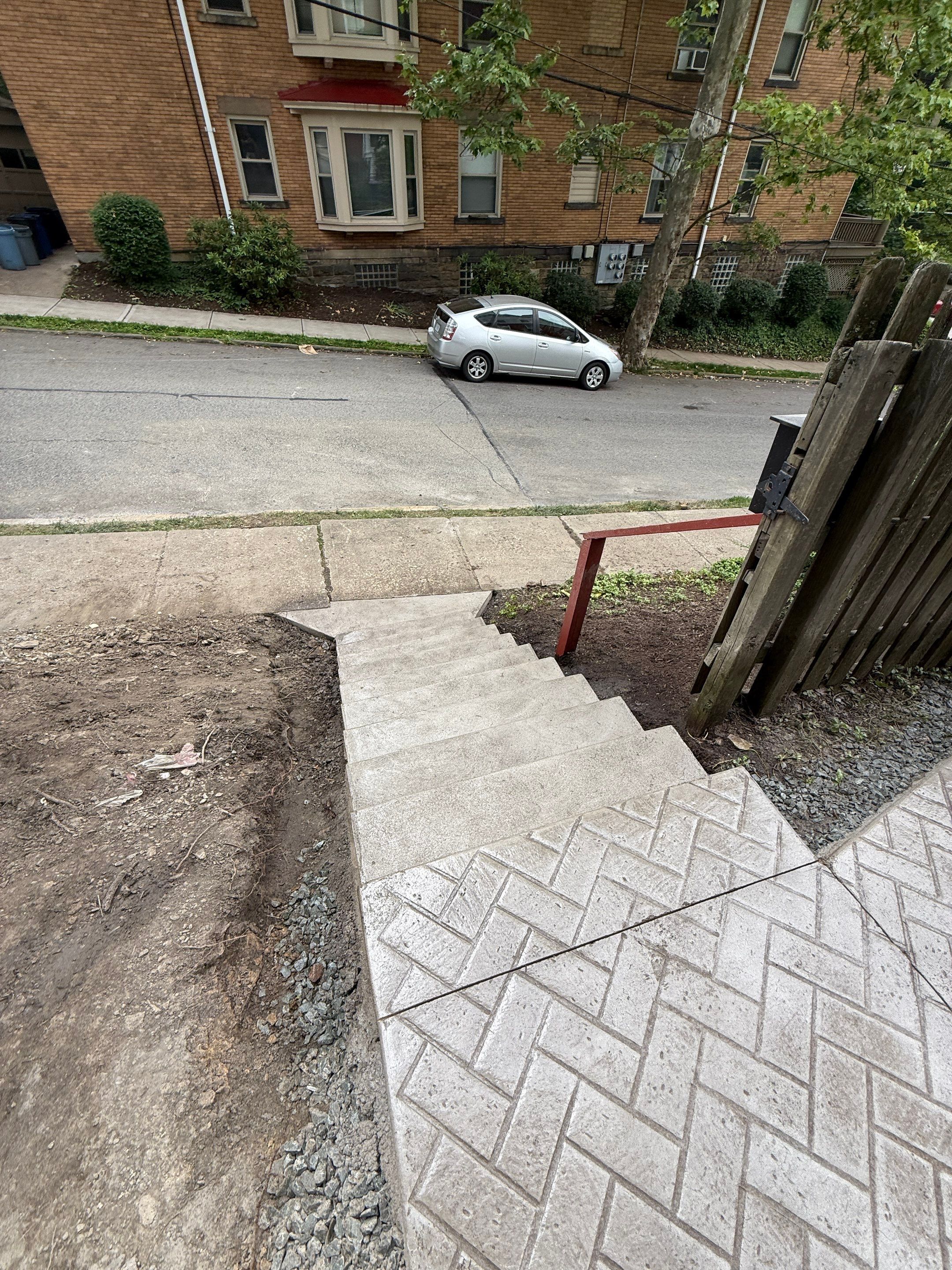 Stamped Concrete and Retaining Wall by Cousins Roofing Siding & Decks