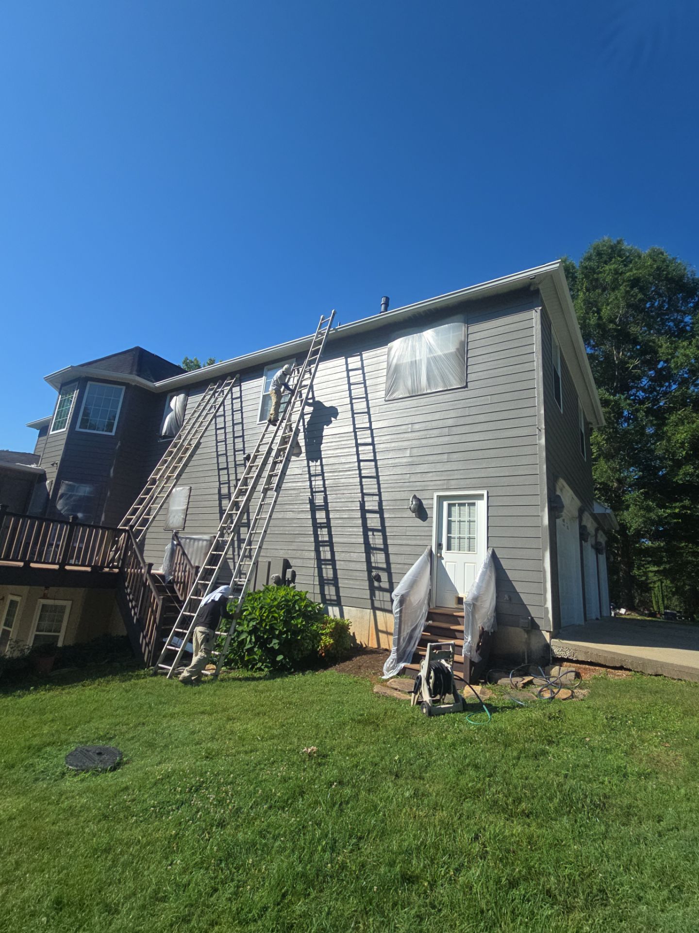 Siding replacement, exterior painting, and front door staining. by GonzalezPainters & Contractors Inc