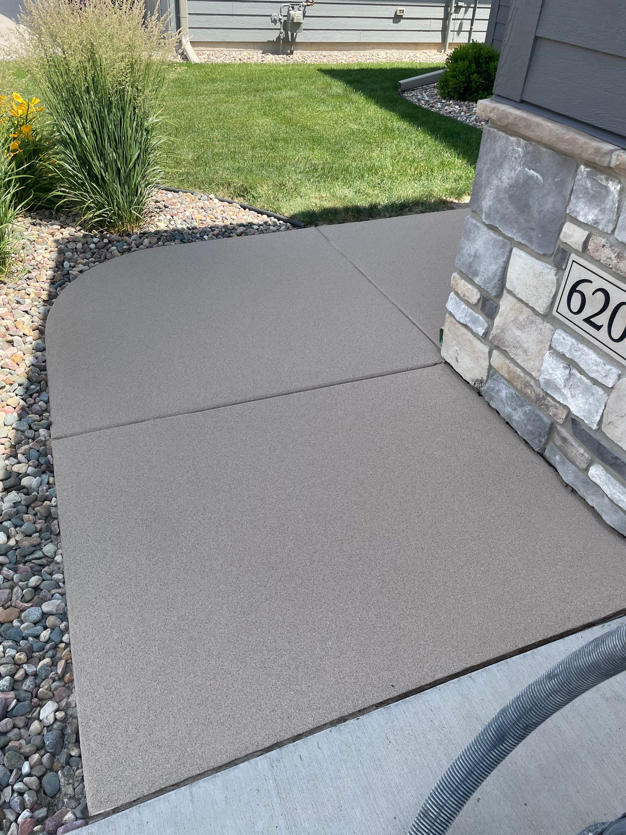 Textured Concrete Patio Coating and Custom Privacy Pergola in Sioux Falls by Select Painting, Coatings & Garage Cabinets