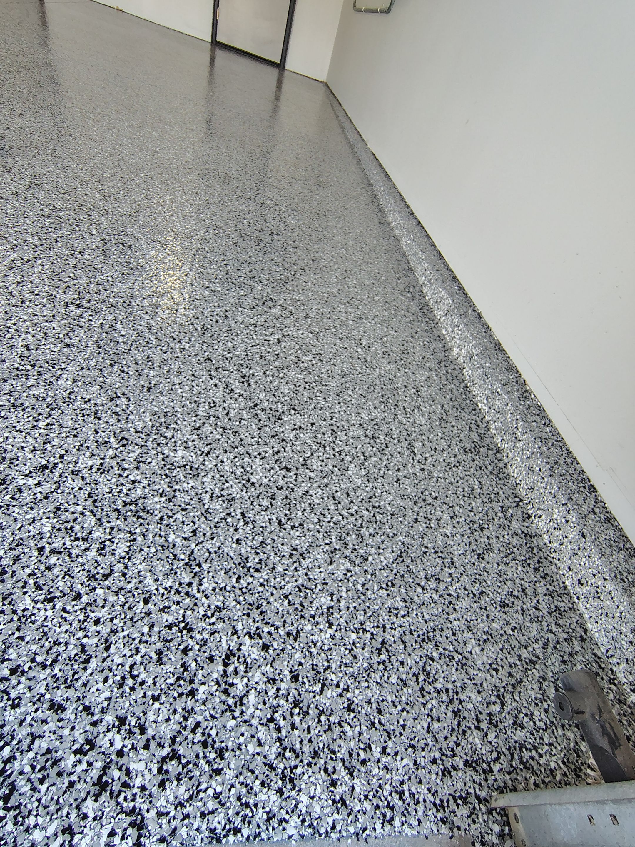 Custom Epoxy Garage Floor Coating Installation in Sioux Falls by Select Painting, Coatings & Garage Cabinets