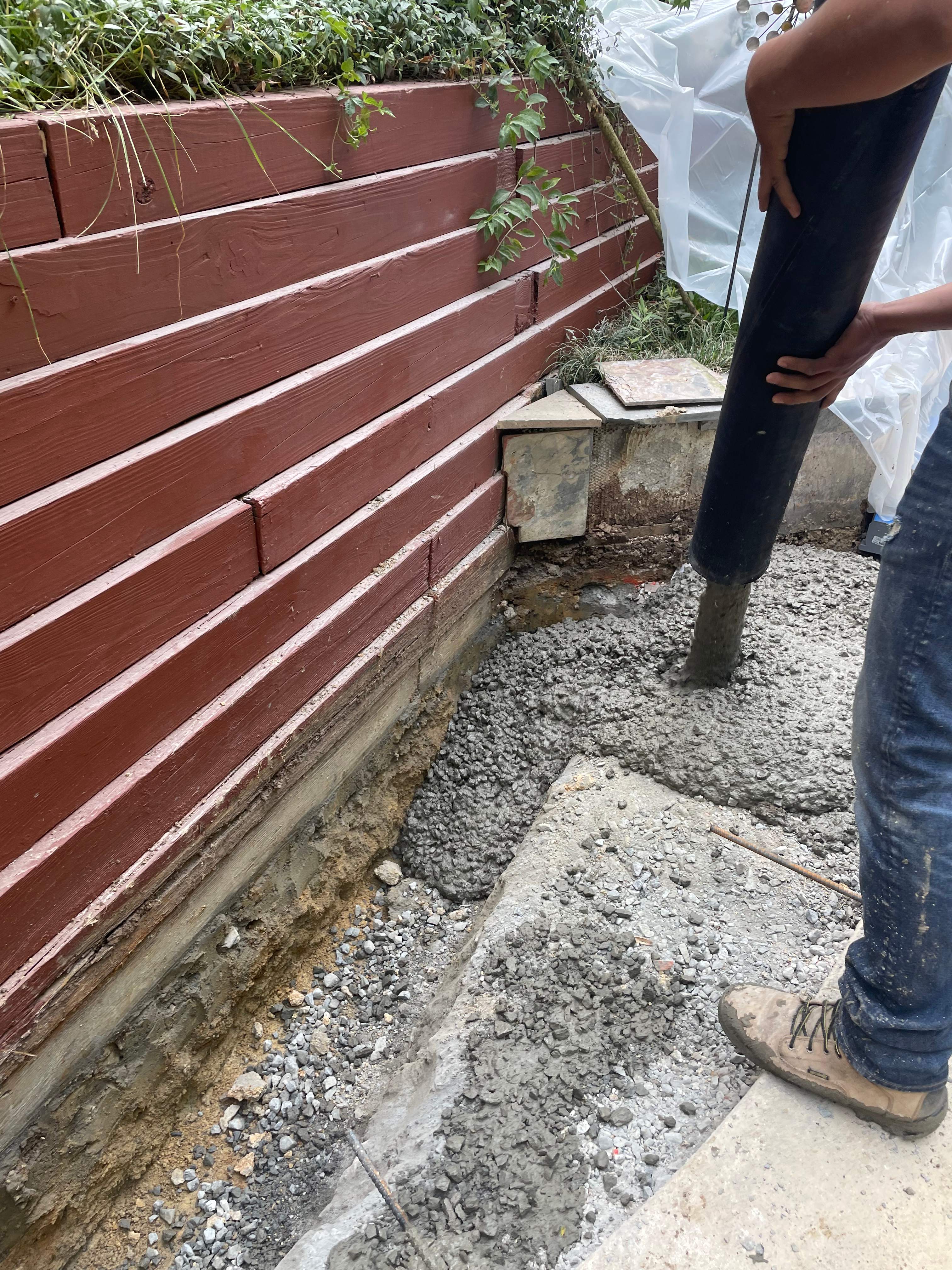 Pool Surround remodel with retaining walls, new waterfall and water slide by Fairfax Contractors, LLC