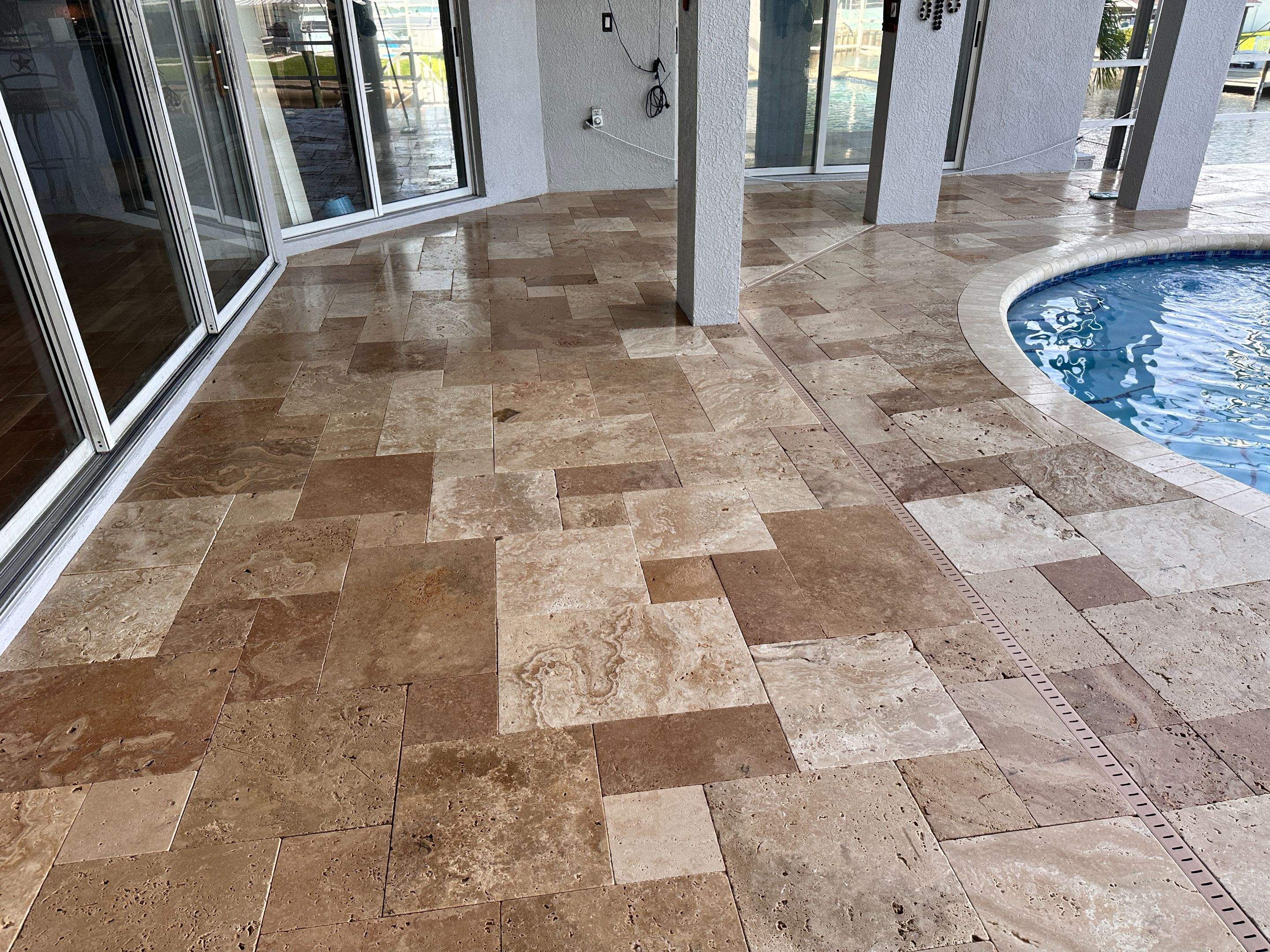 Travertine Sealing and Stripping for a Waterfront Pool Deck in Apollo Beach by Supreme Paver Experts