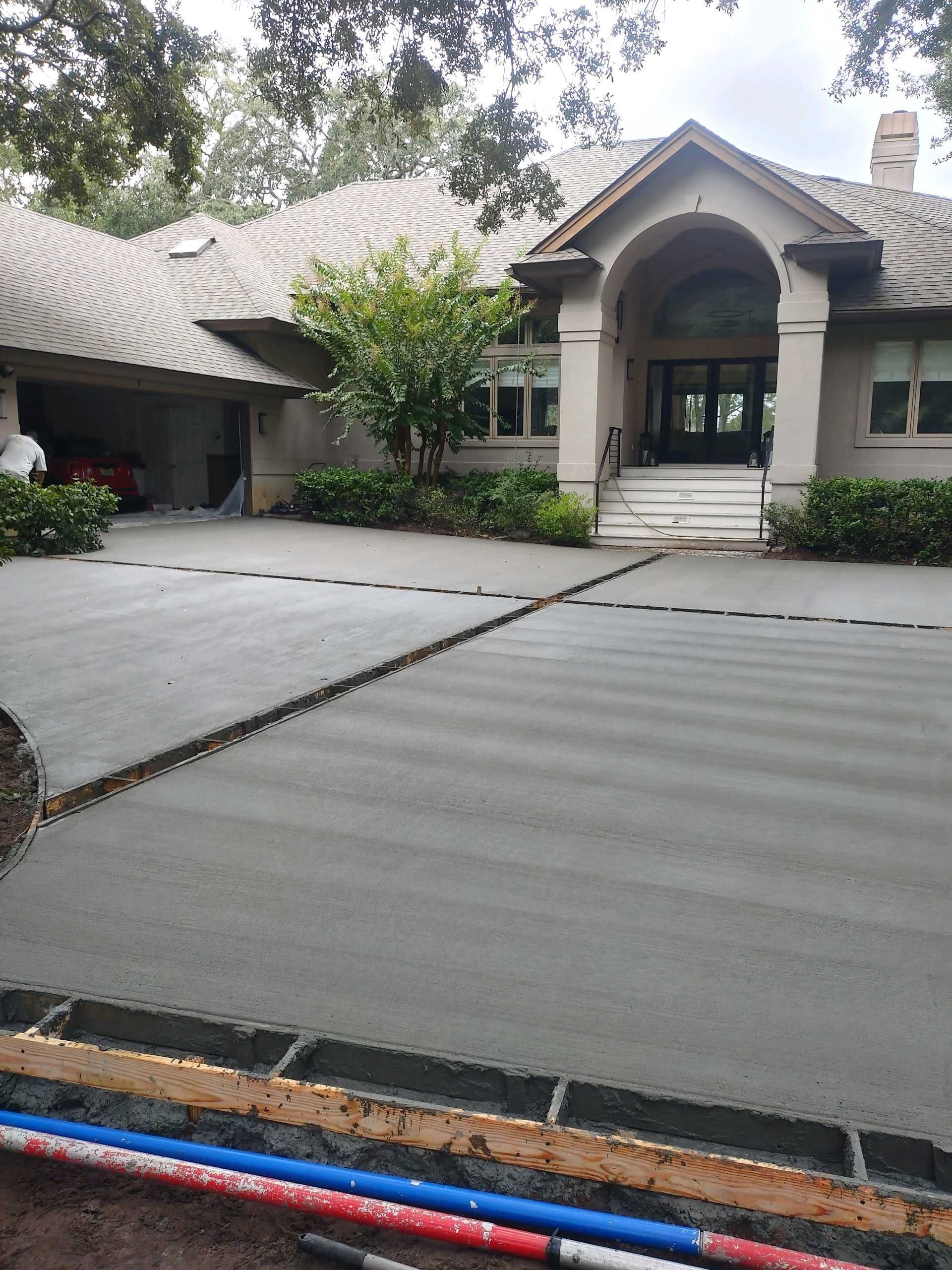Custom Concrete Driveway with Decorative Paver Inlays in Hilton Head Island by Lowcountry Scapes, LLC