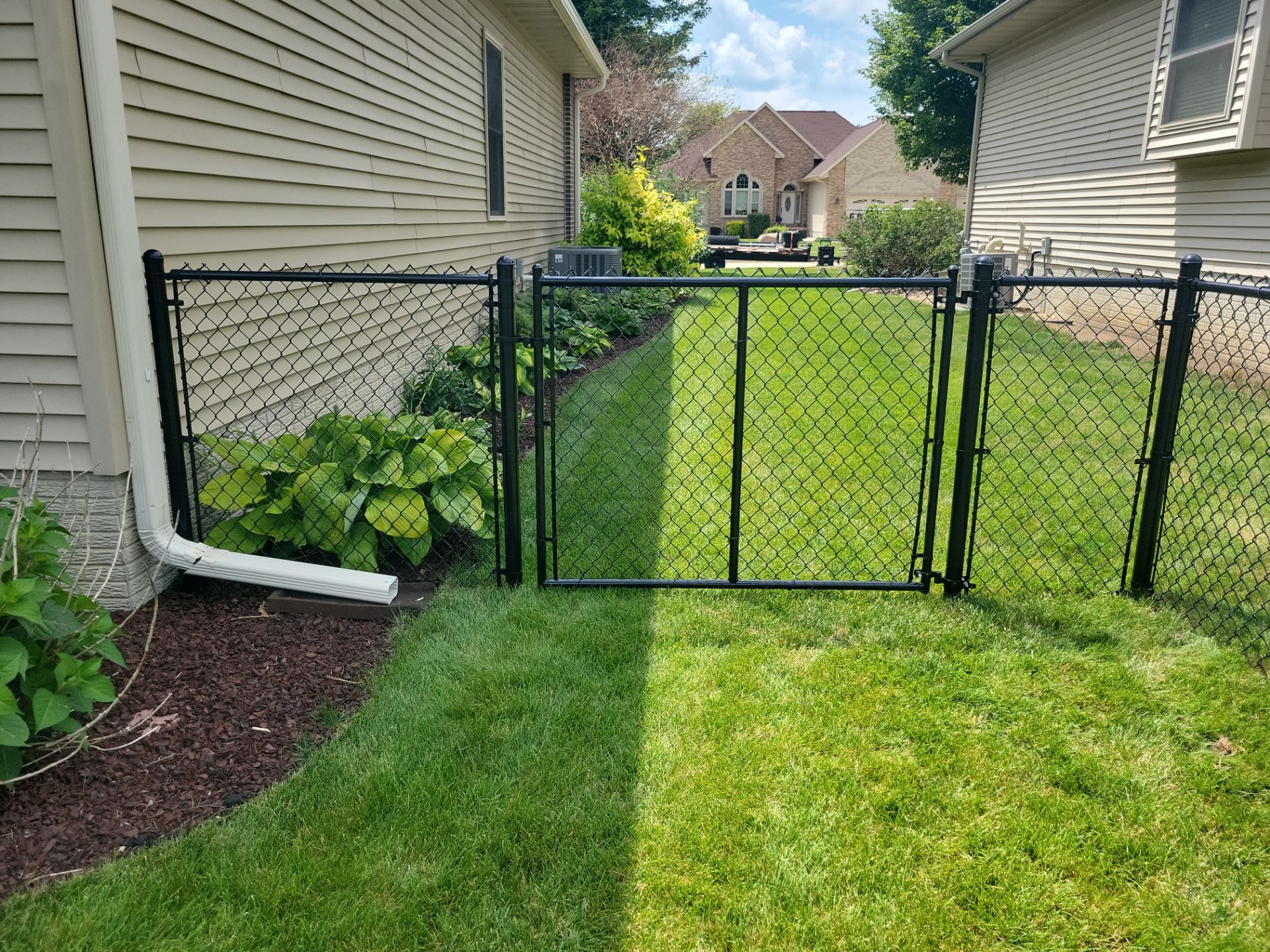 Black Vinyl Coated Chain Link Fence Installation in Cedar Falls by Perfect Picket Fence and Stain