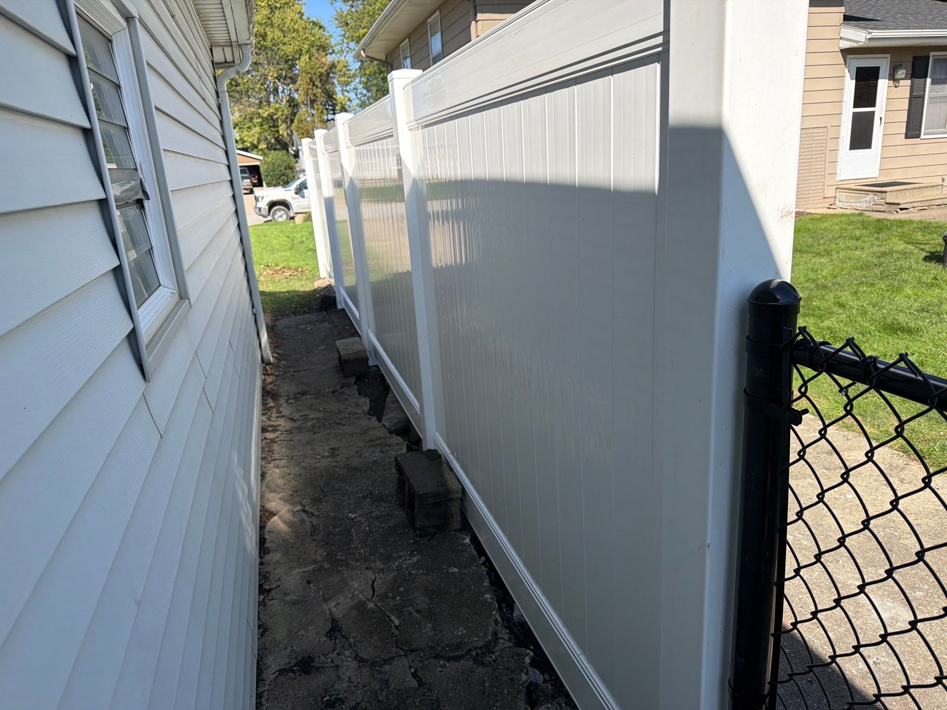 Custom Vinyl Privacy and Black Chain Link Fence Installation in Cedar Falls by Perfect Picket Fence and Stain
