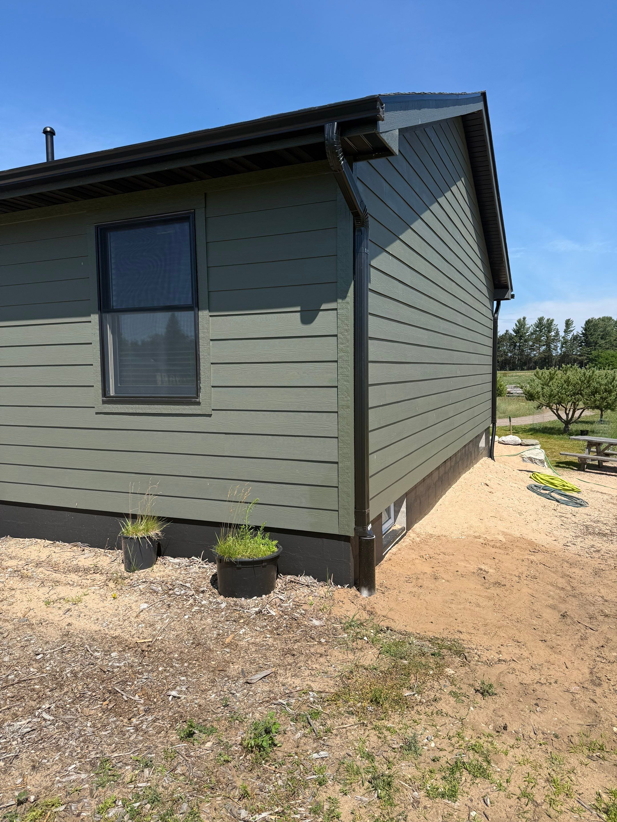 Seamless Black Gutter and Downspout Installation in Bear Lake by Rainbow Seamless Systems