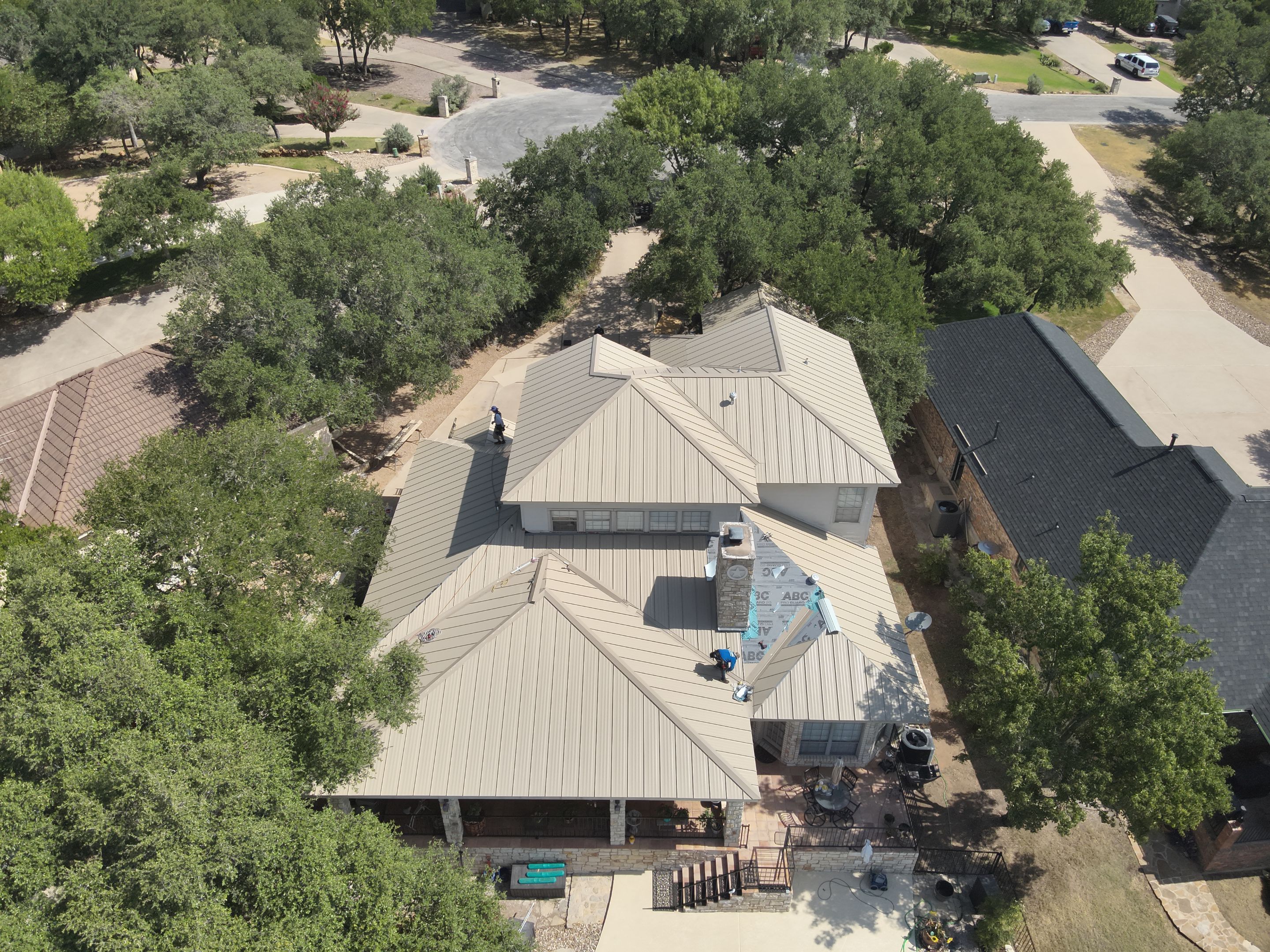 Residential Roof Replacement using 24 GA Double-Lock - Surrey Beige by Action Exteriors Austin