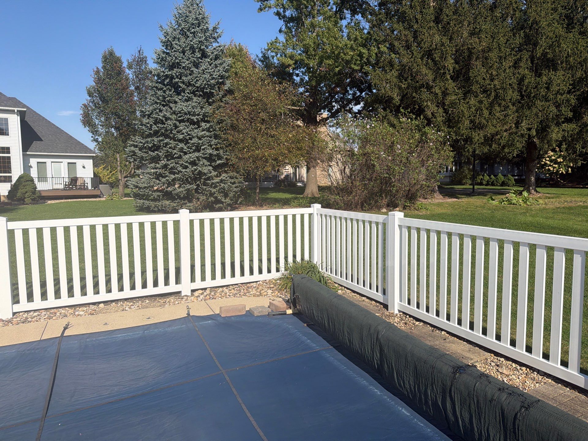 White Vinyl Picket Pool Fence Installation in Waterloo, Iowa by Perfect Picket Fence and Stain