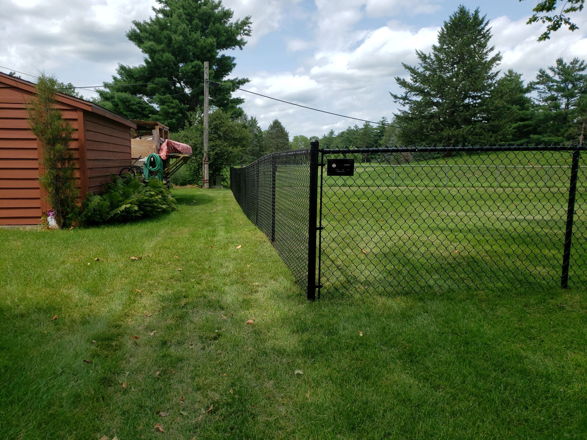 Black Chain Link Fence Installation in Cedar Falls by Perfect Picket Fence and Stain