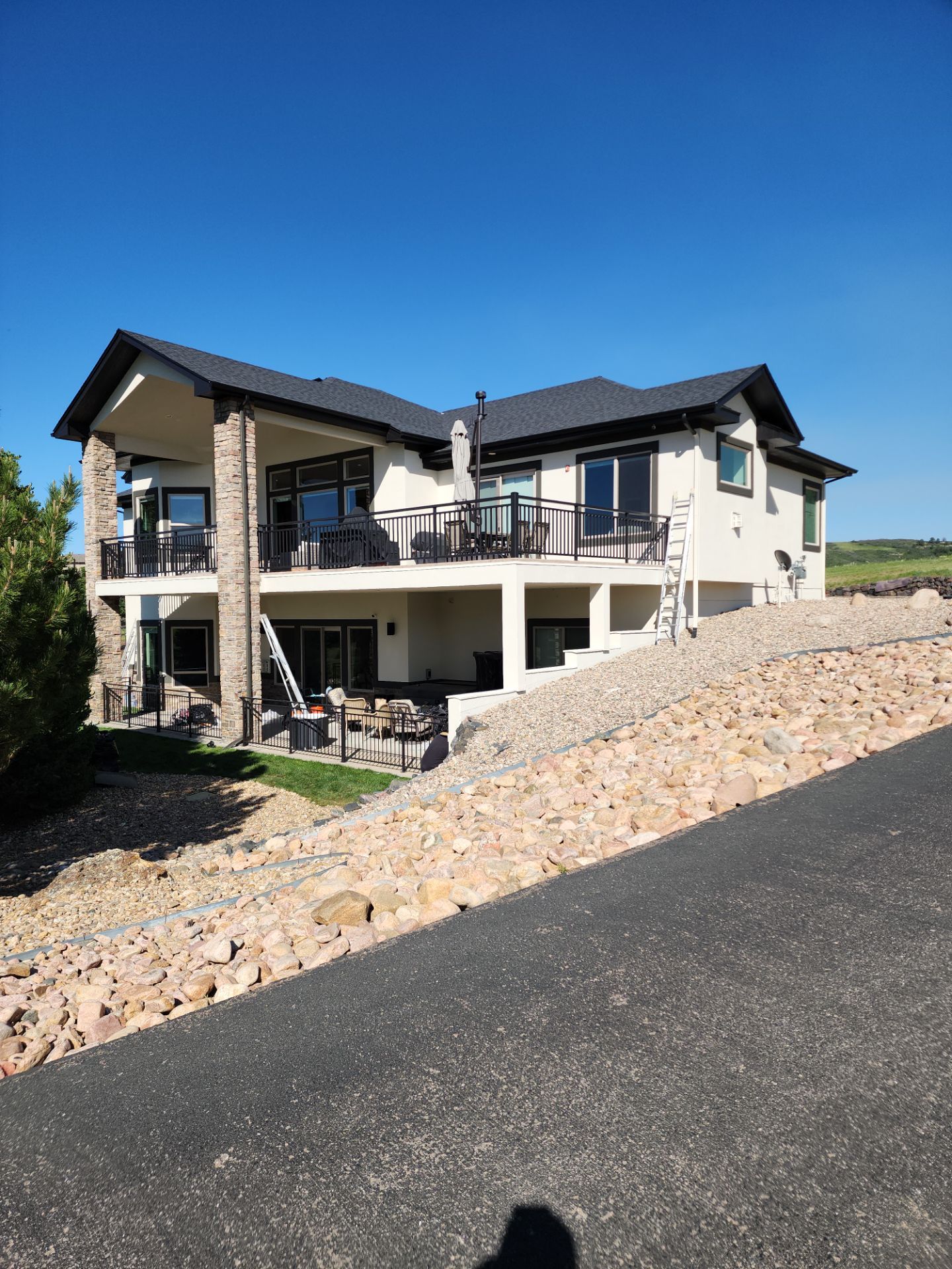 Castle Rock Elegance: White Stucco Exterior with Bold Tricorn Black by J&M Painting LLC