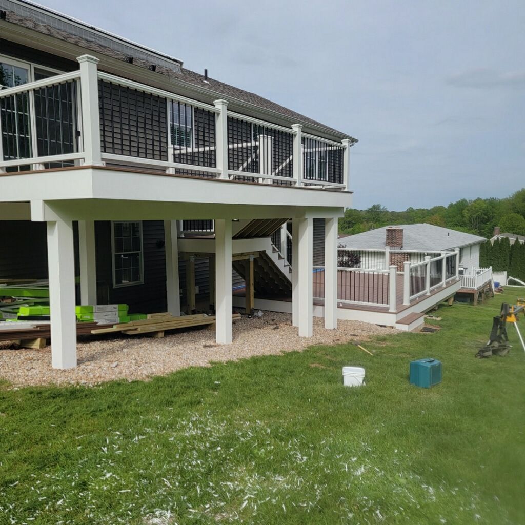 New Two Tier deck using Trex Hatteras boards and White Composite railings. by DiGiorgi Roofing and Siding Inc