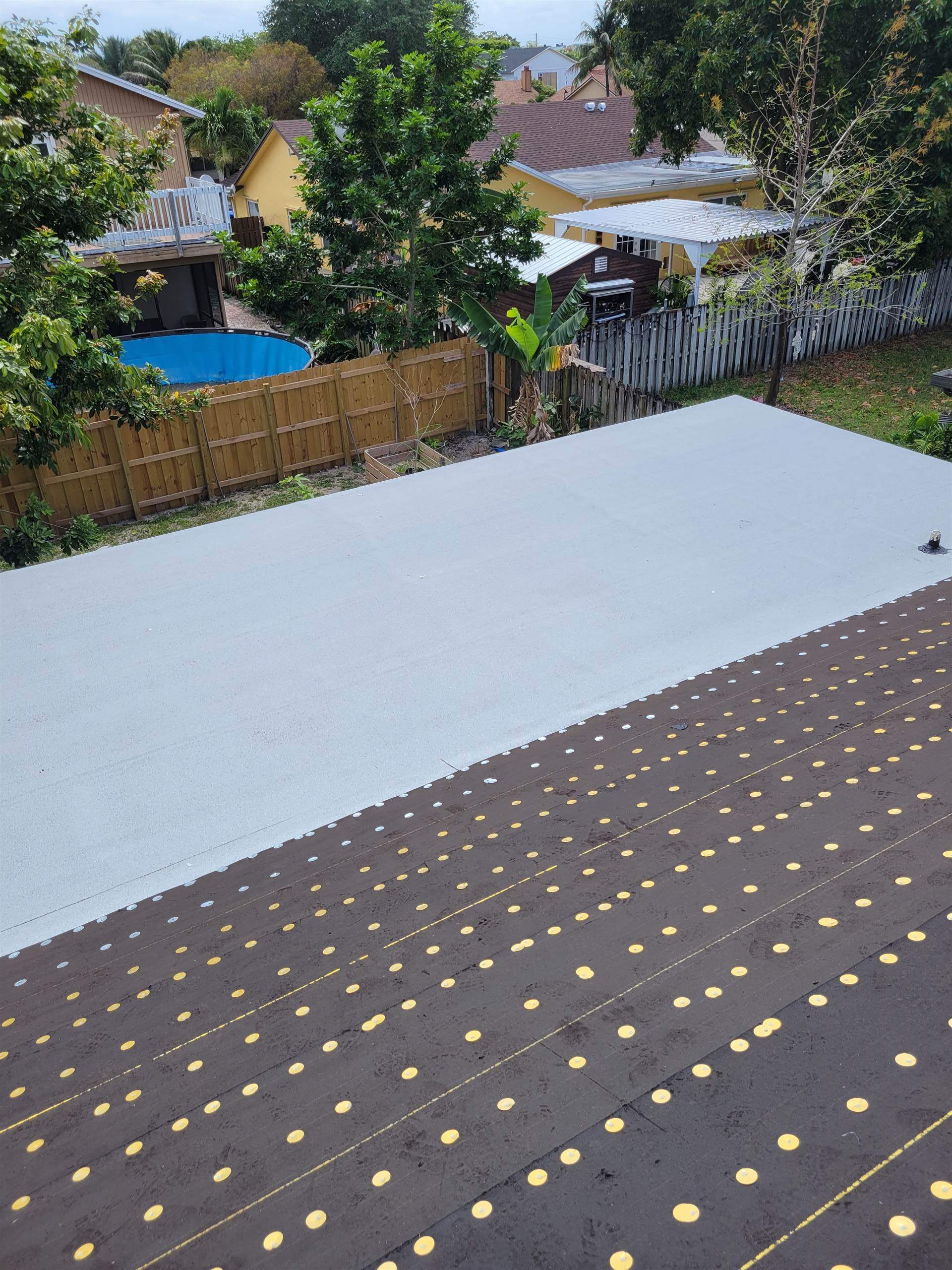 Standing Seam Metal & Flat Re-Roof using 1.5" Nail Strip 24ga Solar White Kynar Coated Standing Seam Metal Panels by Morton Roofing, Inc.