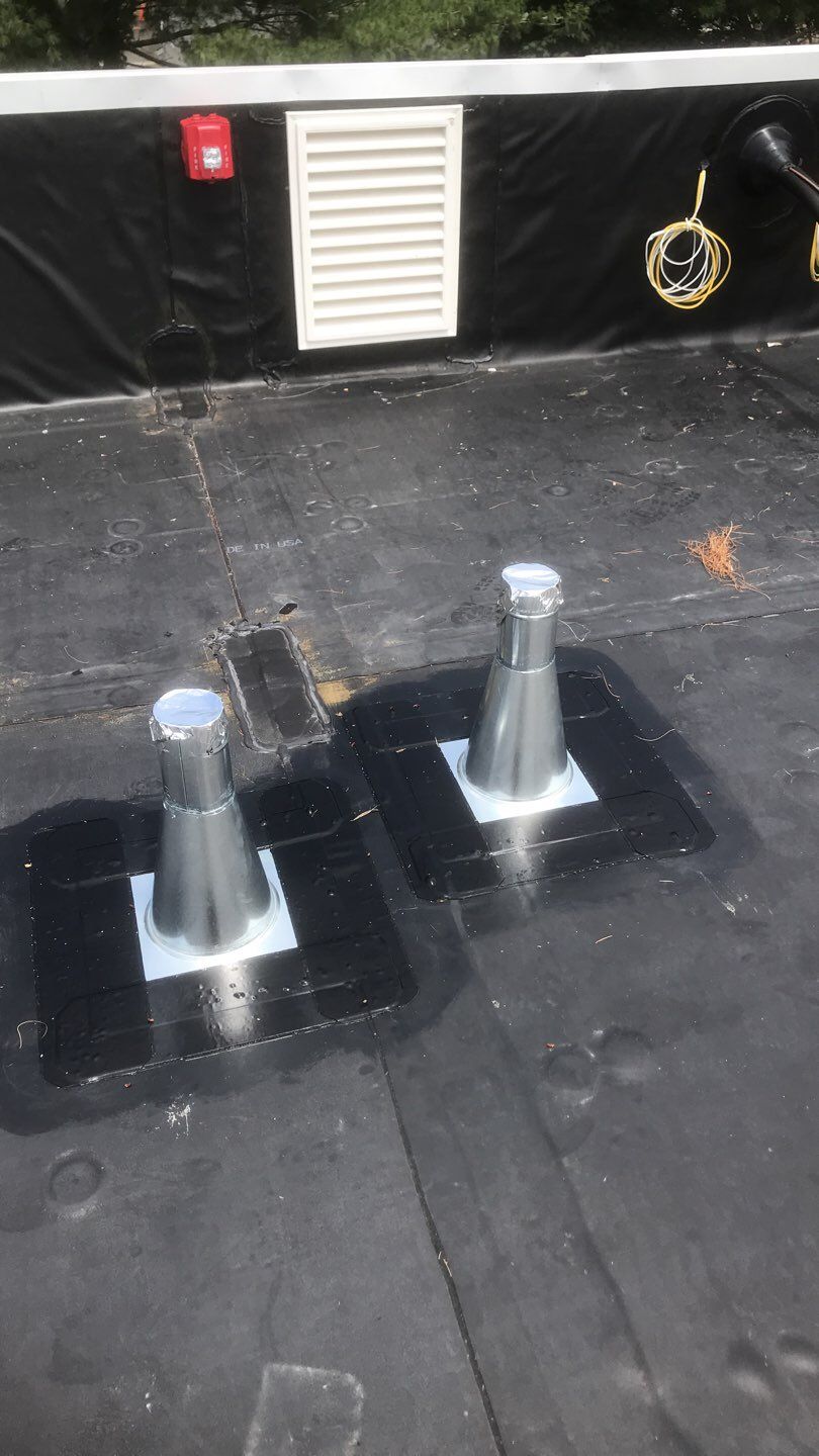 Commercial Roofing Installation using EPDM with white gutters by A Plus Exterior